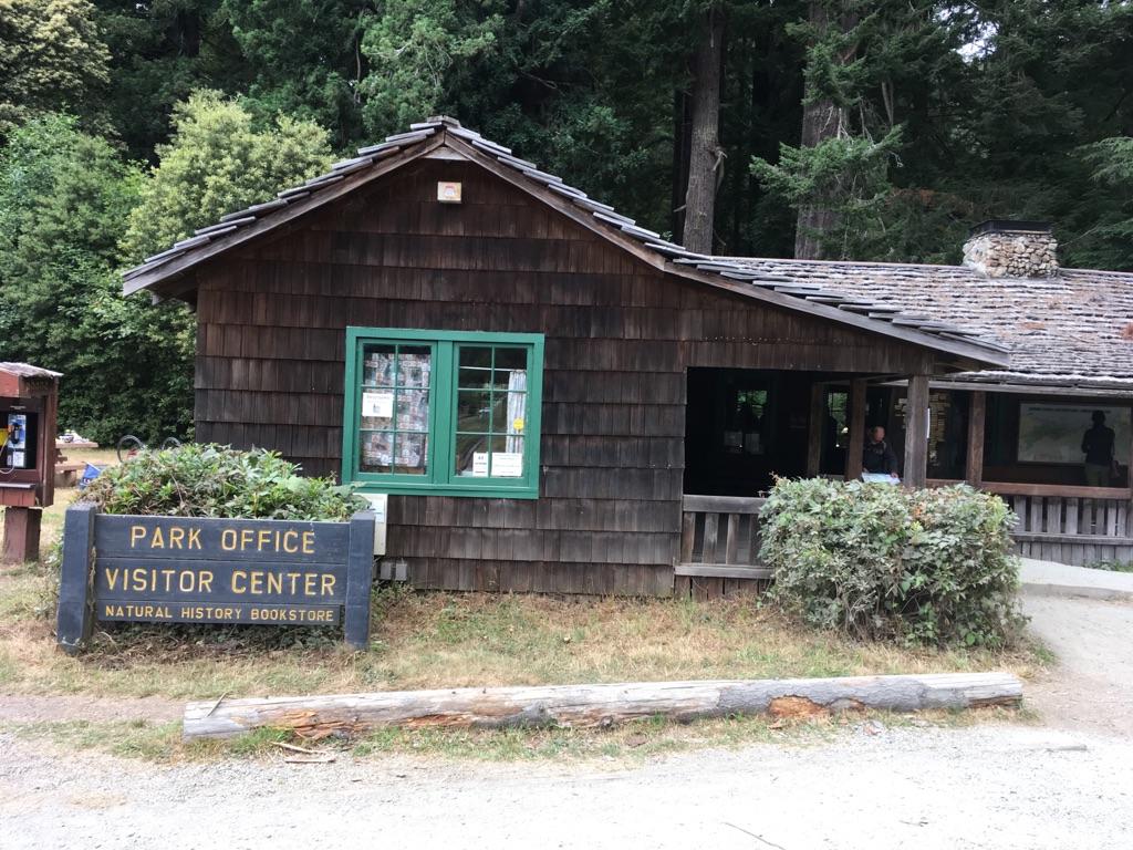 A rustic wooden building with green windows and a "Park Office" sign.