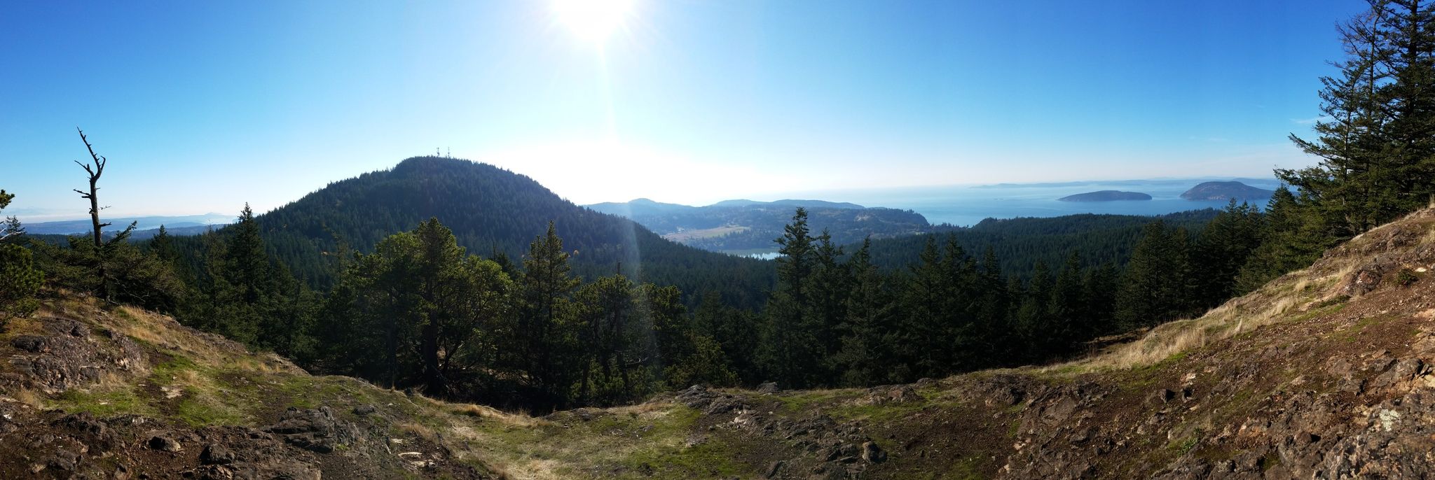 Panoramic view of a forested mountain and distant water on a bright, sunny day. - Sugar Loaf & Mount Erie loop