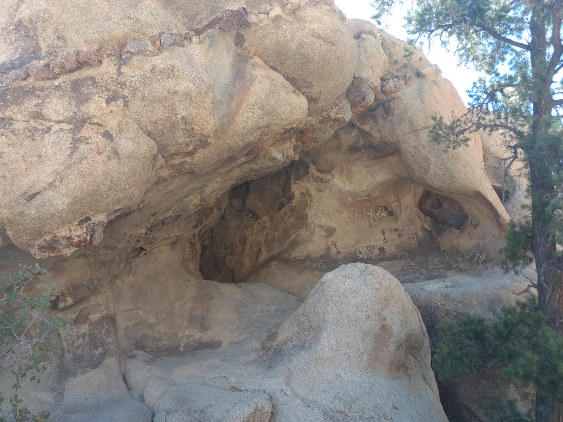 Close-up of large, weathered rock formations with natural caves.