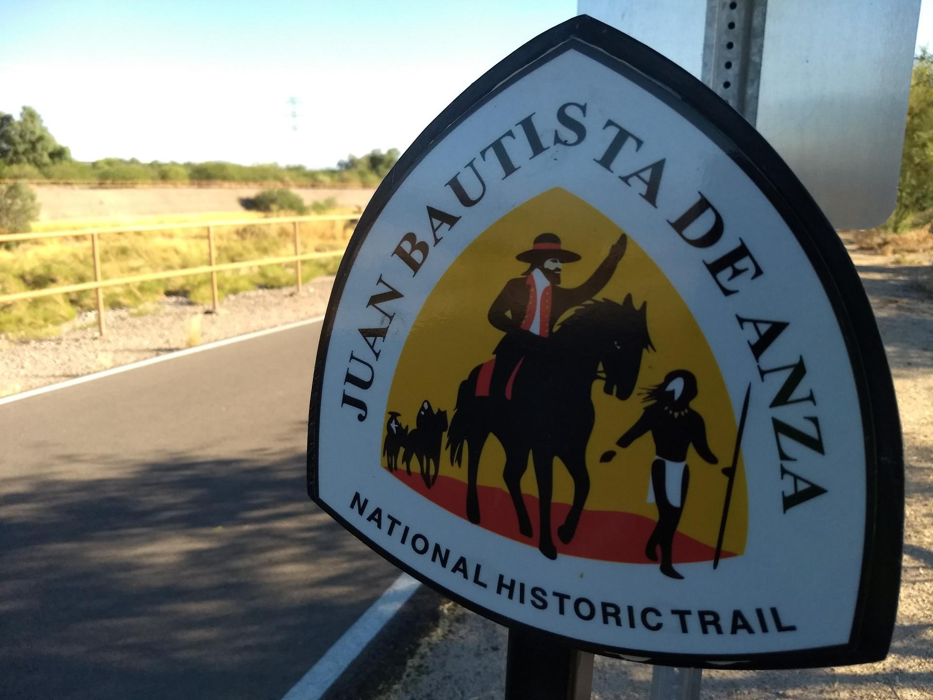 Close-up of a trail sign depicting a person on horseback and a person walking.