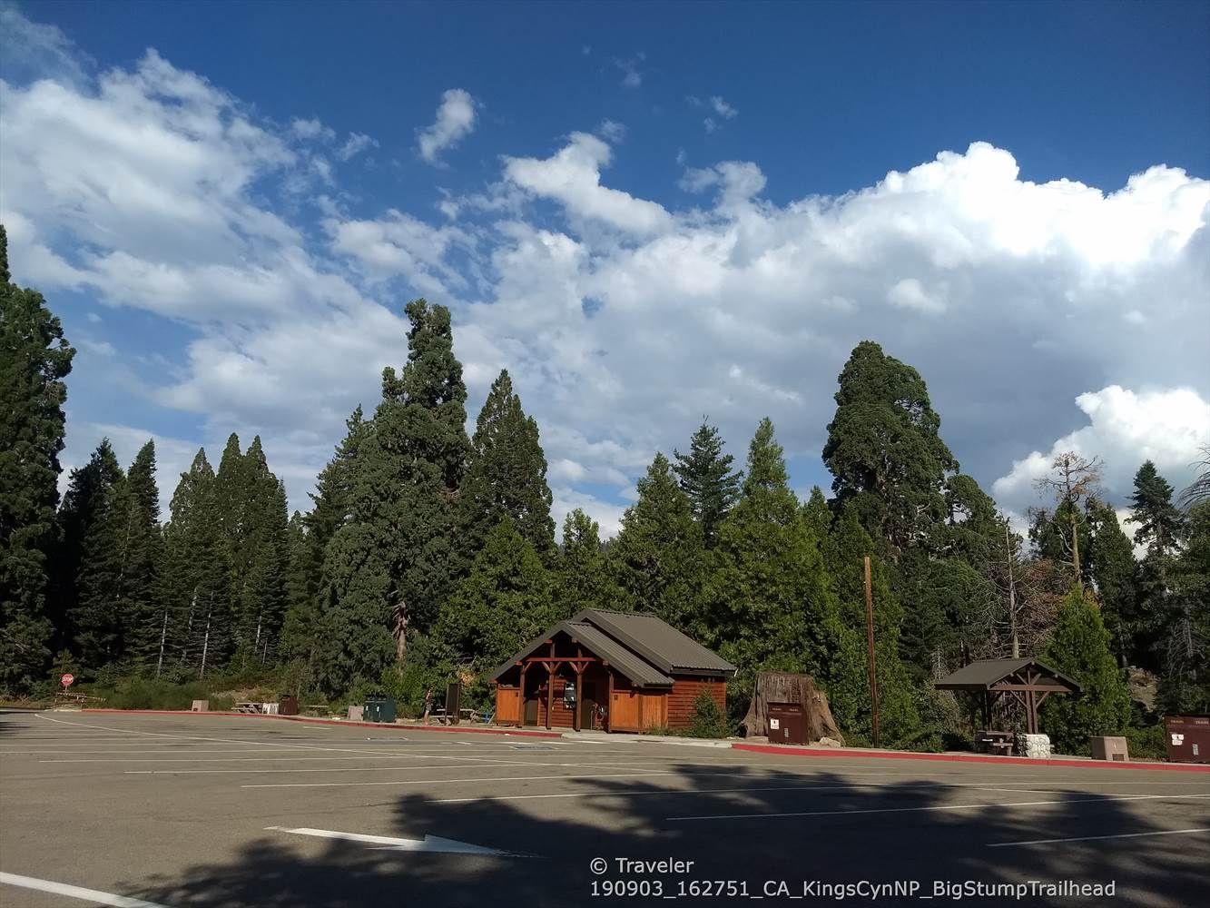 Wooden building and parking lot surrounded by tall evergreen trees. - Big Stump to Kings Canyon Overlook via General's Highway