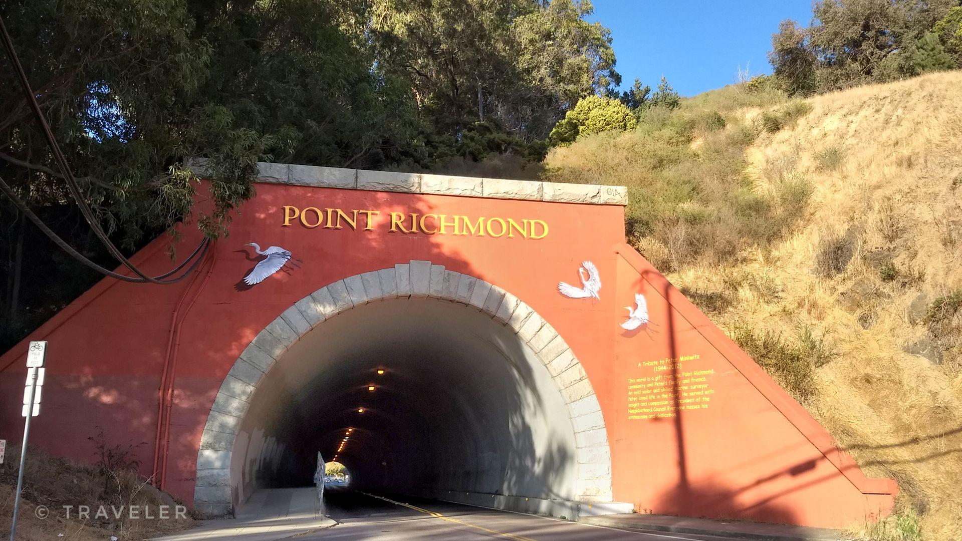 Red tunnel entrance with "POINT RICHMOND" text and white bird murals.