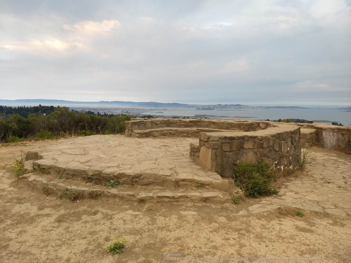 Circular stone structure on a hilltop overlooking a bay under cloudy skies. - Wildcat Peak – Wildcat Peak Trail loop from Tilden Regional Park