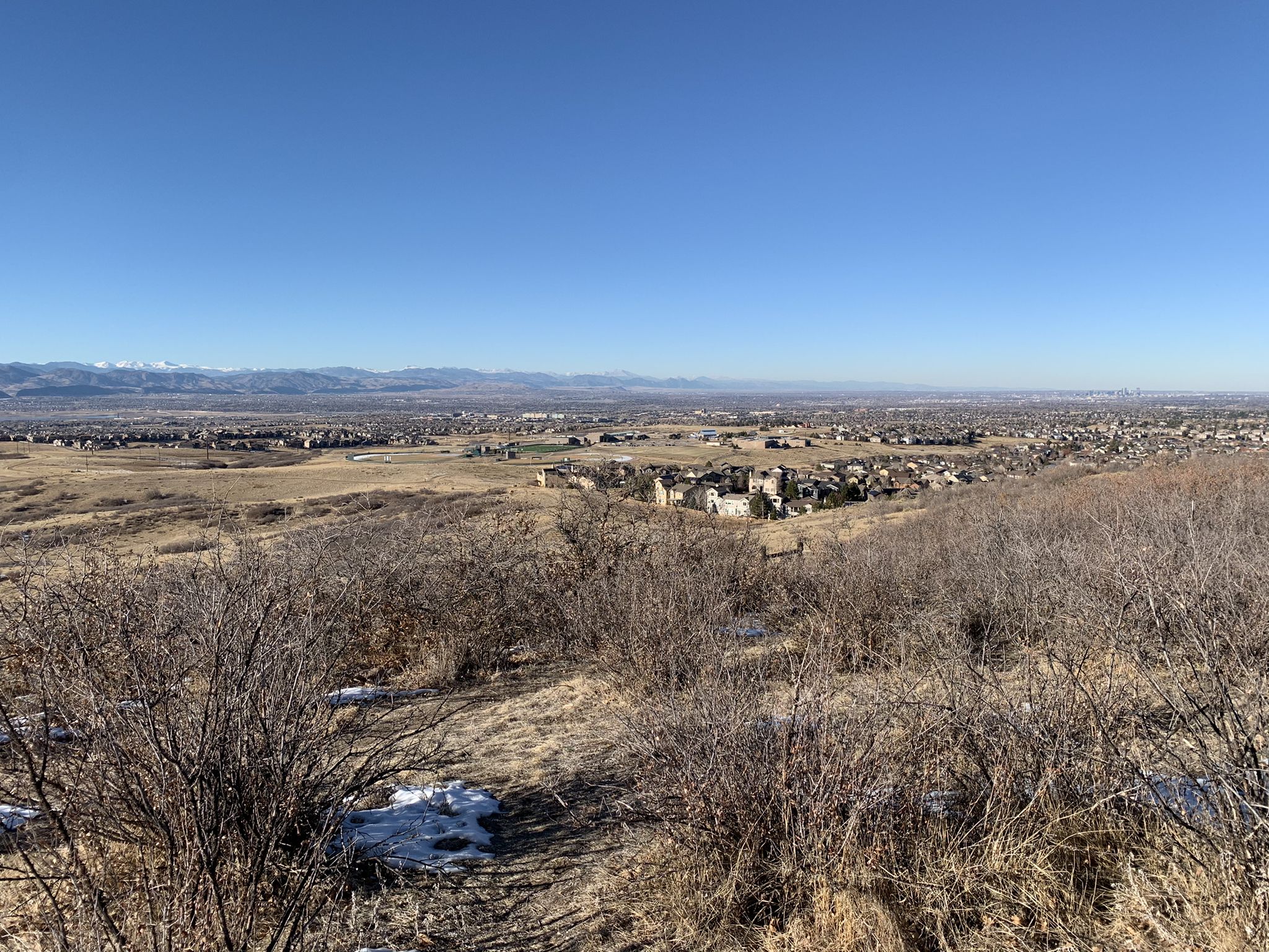 Panoramic view of a town and distant mountains under a clear blue sky. - Highlands Point Viewpoint – Bluffs Regional Park loop from Sky Ridge