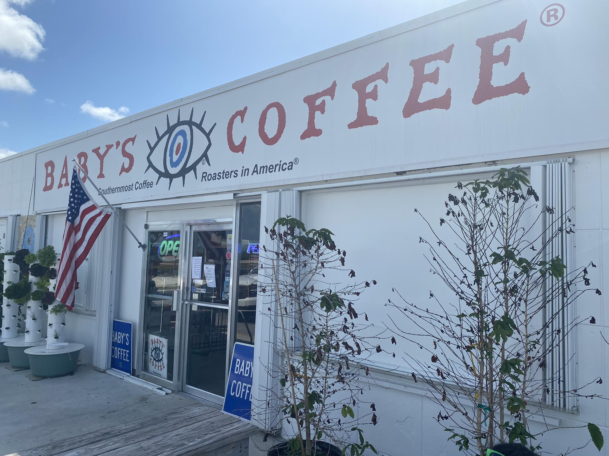 Exterior of a coffee shop with an American flag on a bright day.