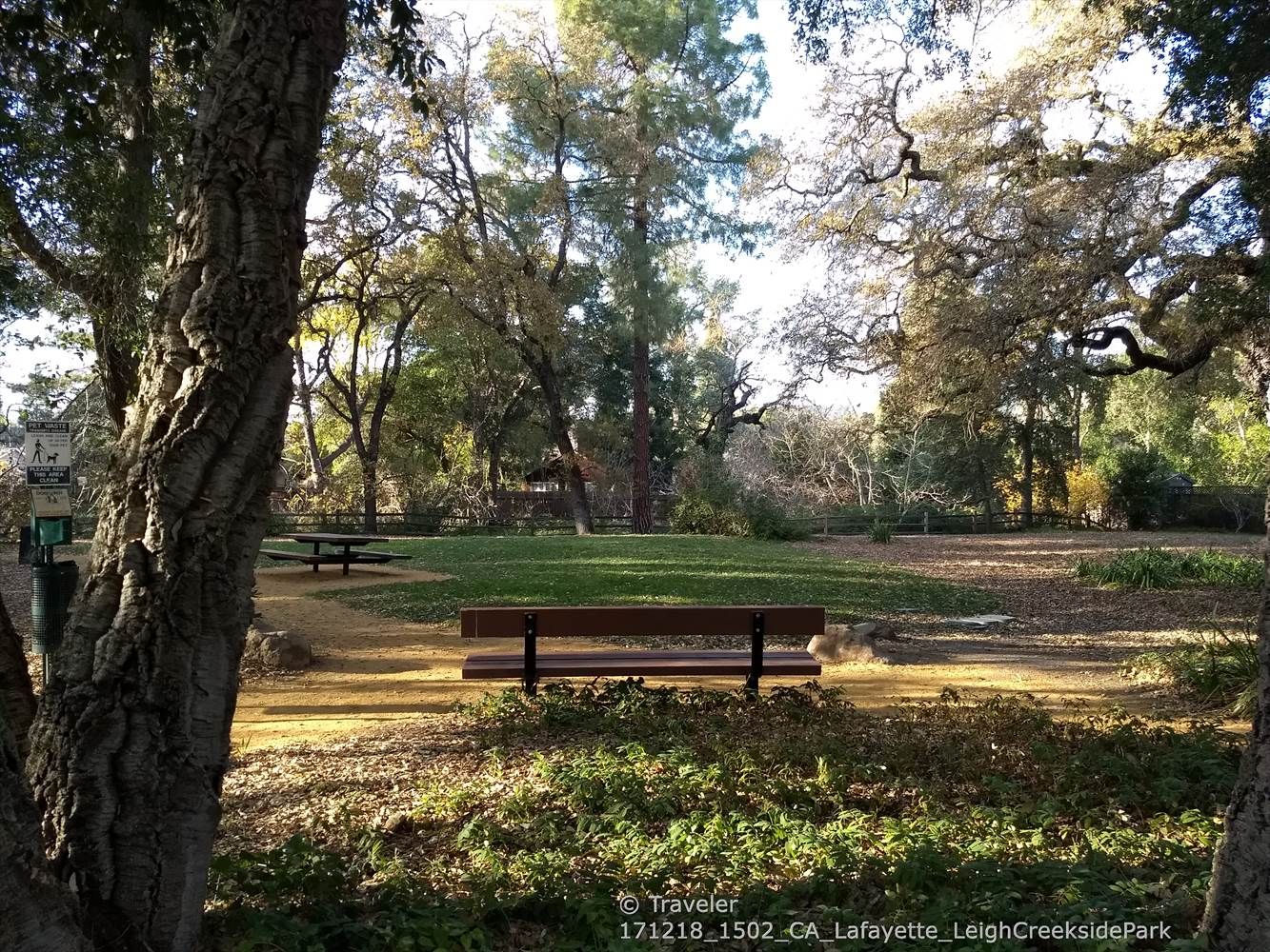 Park benches and picnic table in a grassy clearing surrounded by trees. - Lamorinda Trail Loop