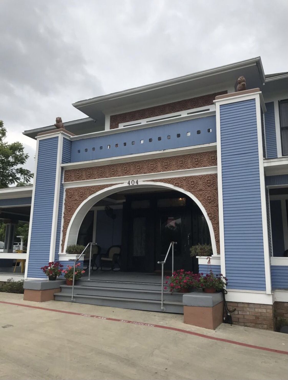 Ornate blue and brown building entrance with steps and potted flowers. - Dallas Zoo to Mary Lou’s via Joe Loop Lake