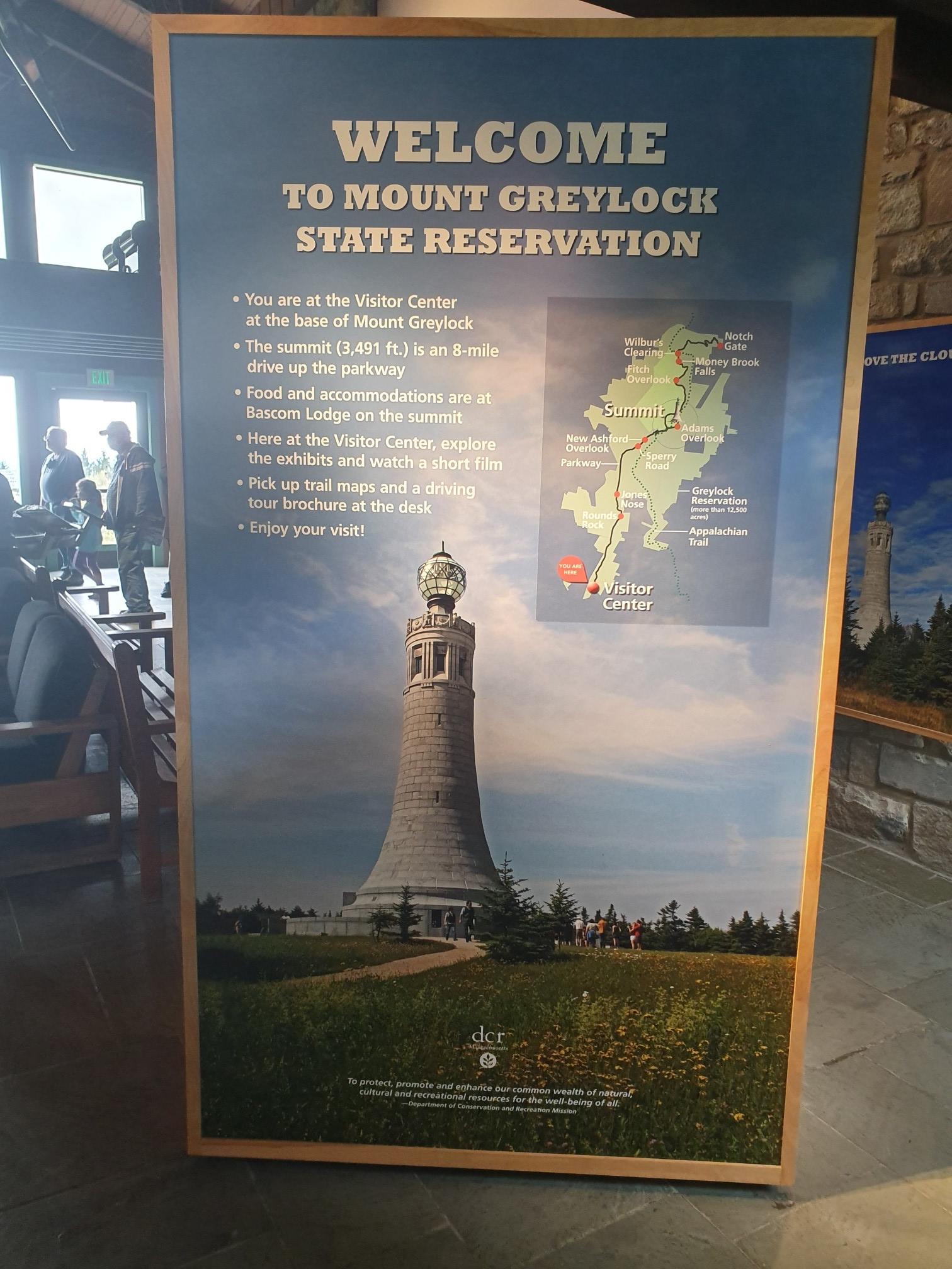 Large informational sign with text and graphics, inside a building, no human activity.