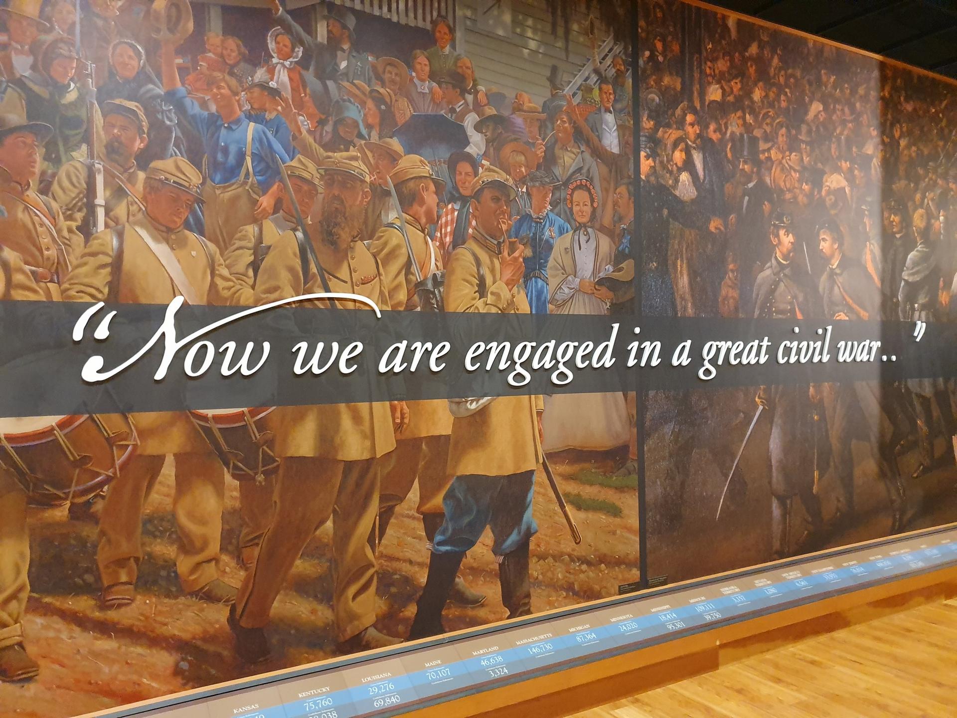 Large historical mural depicting soldiers and civilians with an overlaid quote.