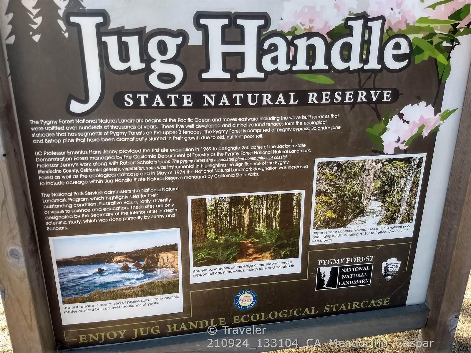 Large wooden information sign with text and images of natural landscapes.