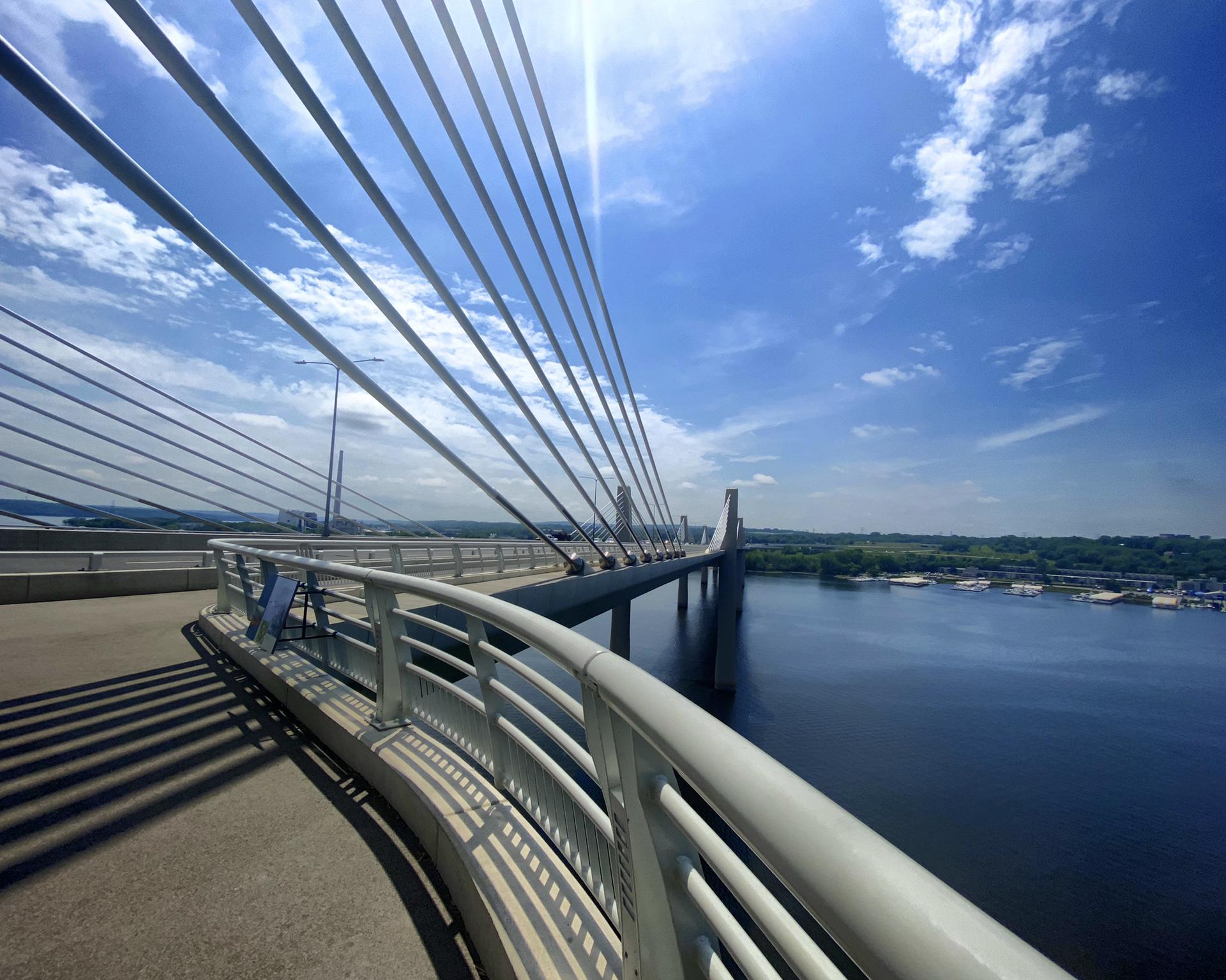 Modern cable-stayed bridge over water on a bright sunny day.