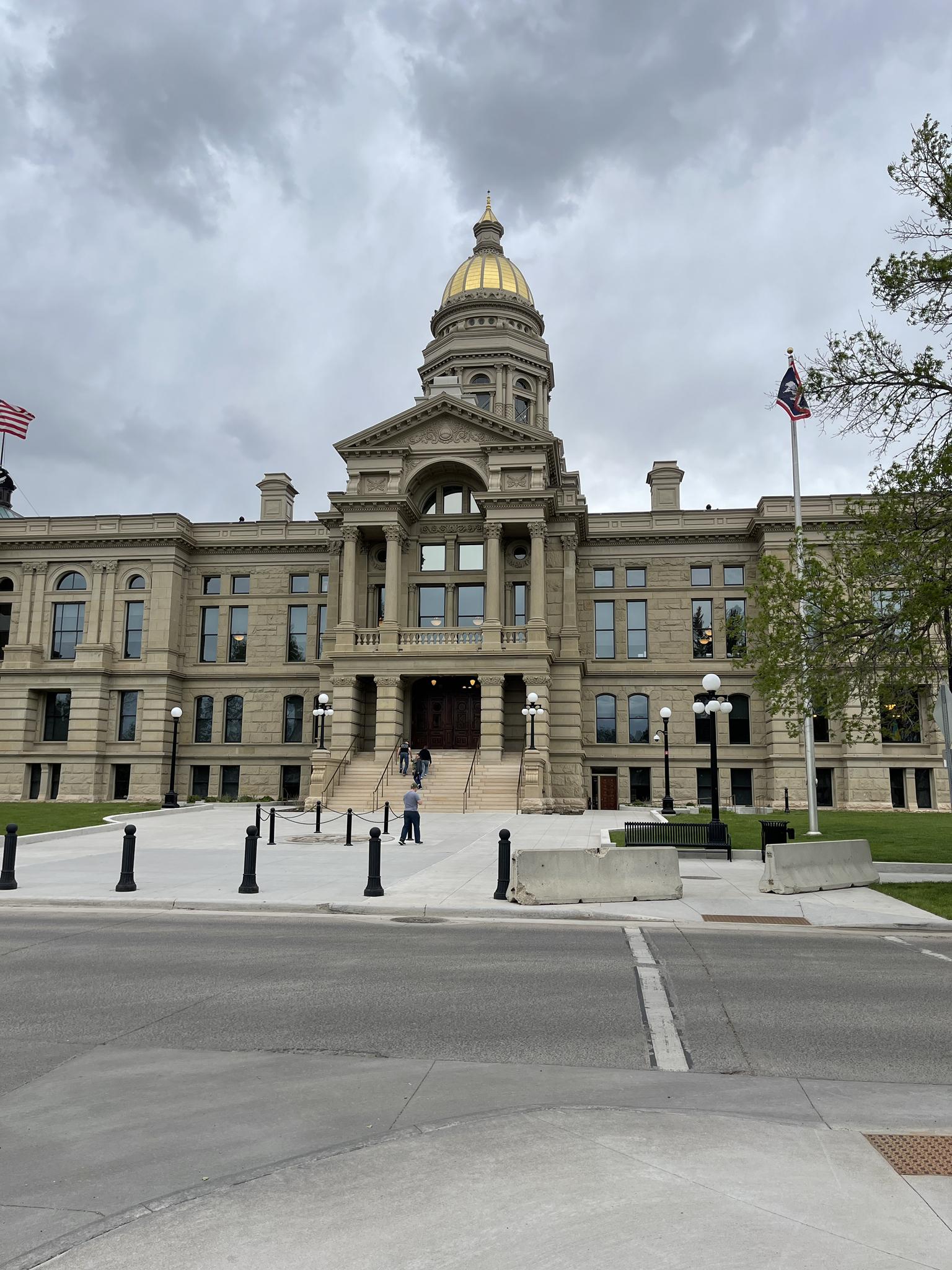 Ornate stone building with a golden dome on an overcast day.