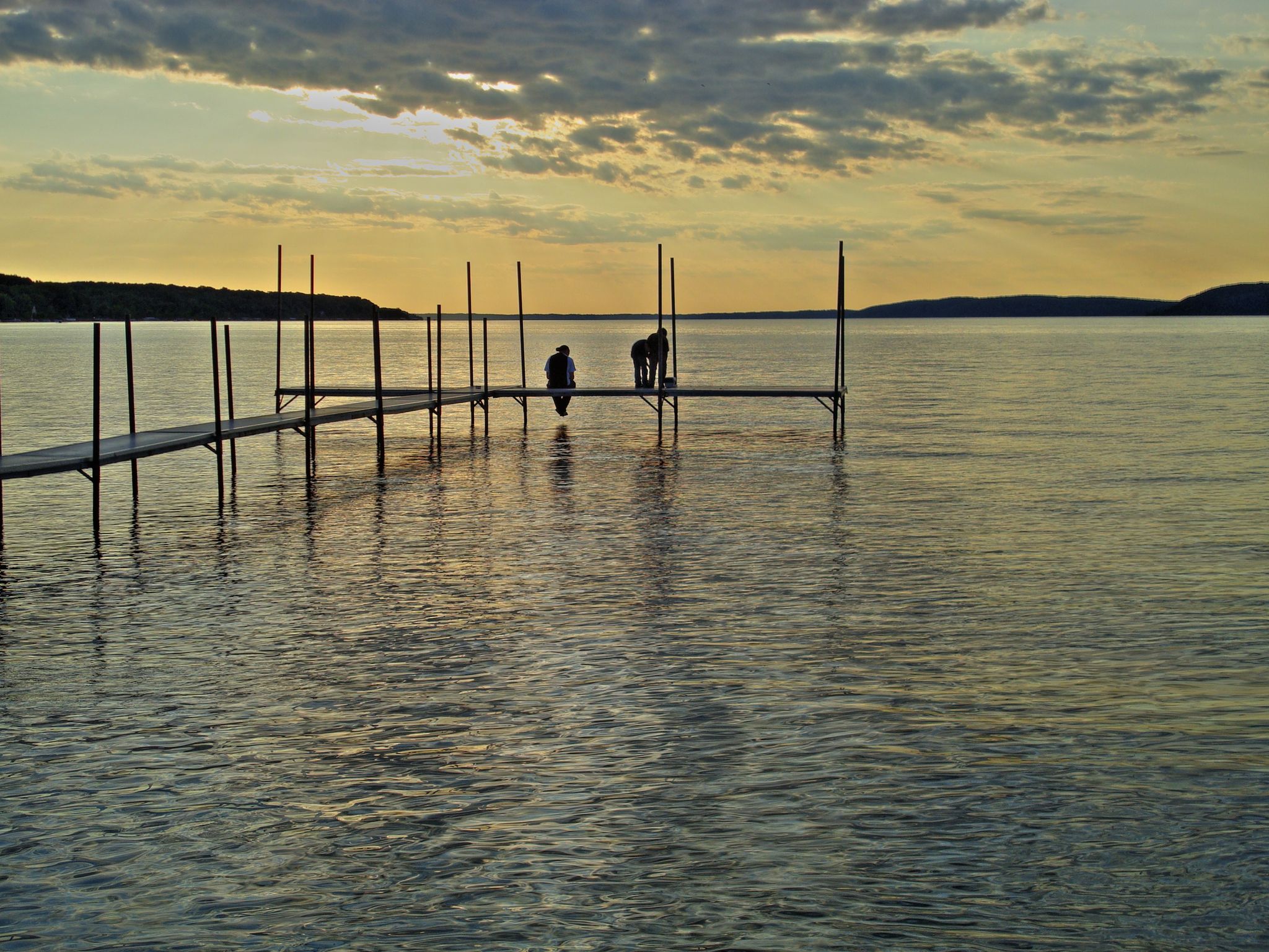 Two people on a long dock over a calm lake at sunset. - Mont Minnie Nature Preserve loop from Platte River