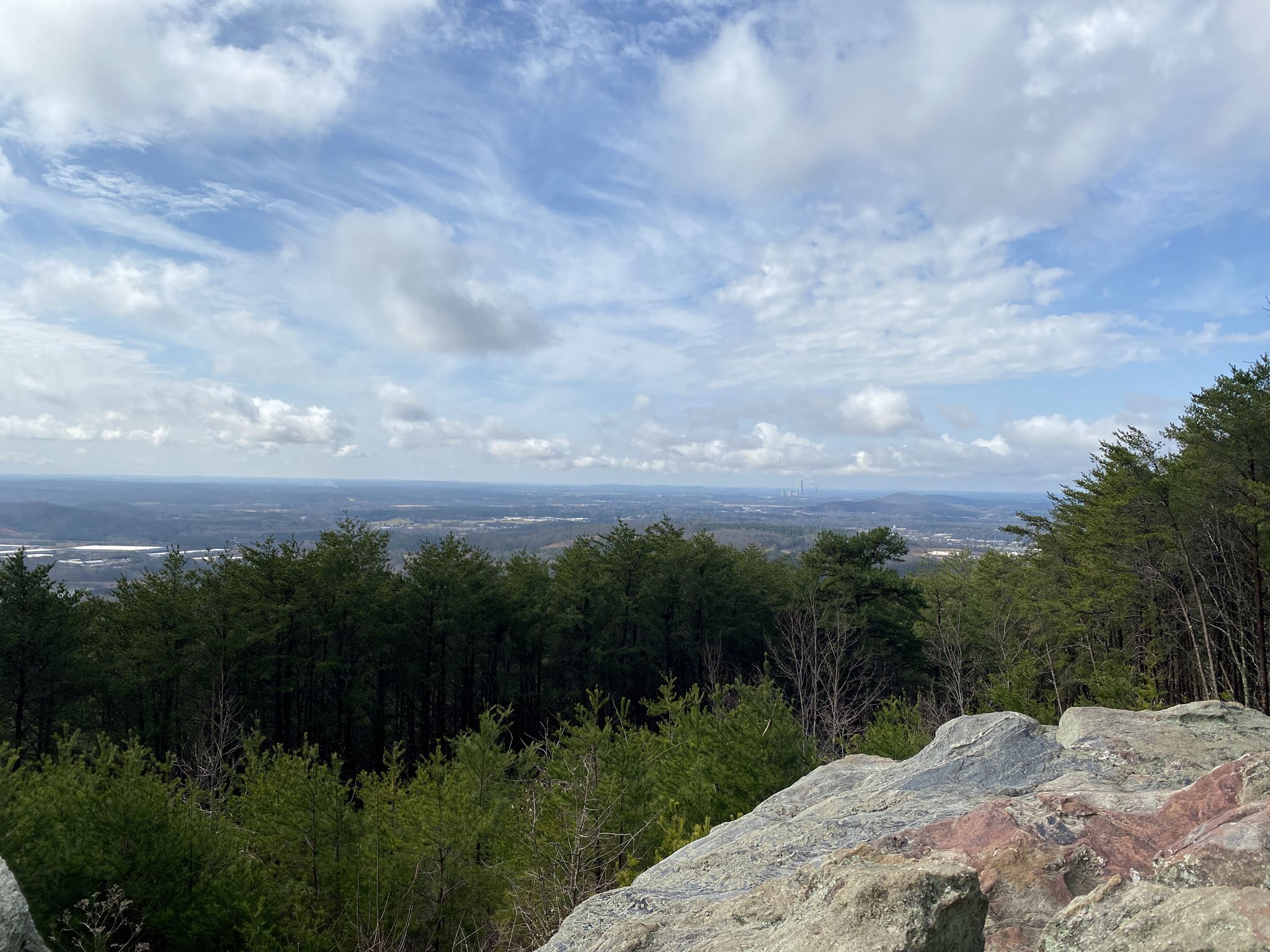 Expansive mountain overlook with green forest, distant valley, and cloudy sky. - Pine Mountain West Loop