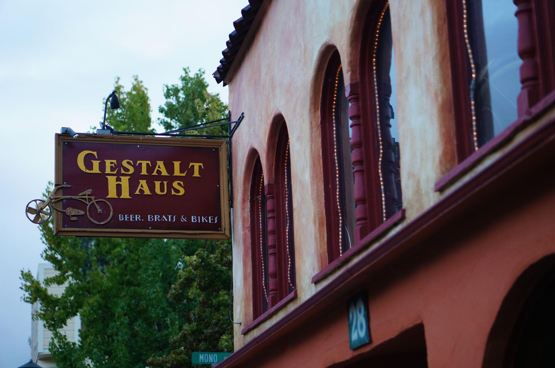Building with 'Gestalt Haus' sign and arched windows under overcast sky.