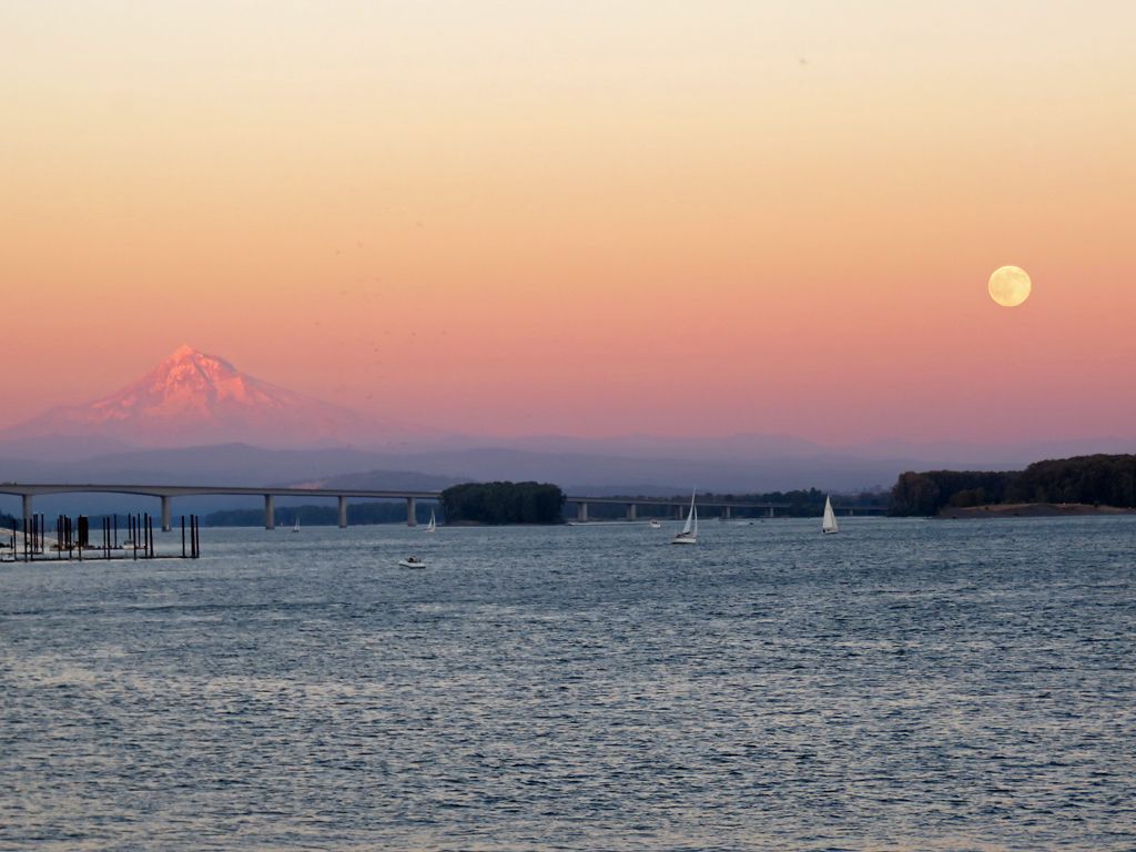 Sunset over a river with a full moon, distant mountain, and sailboats. - Burnt Bridge Creek and Lewis & Clark Trail Loop