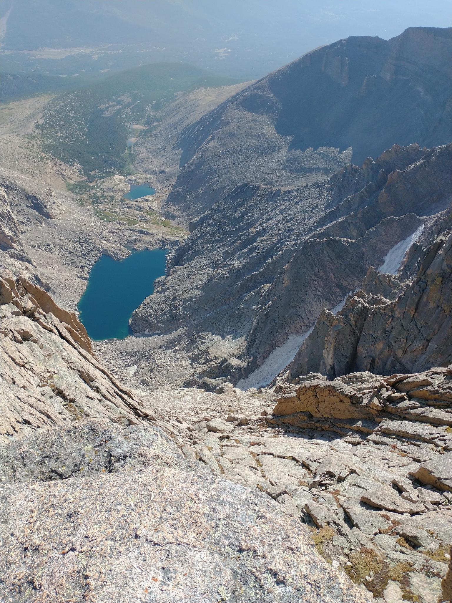 Aerial view of a deep rocky valley with two vibrant blue lakes.