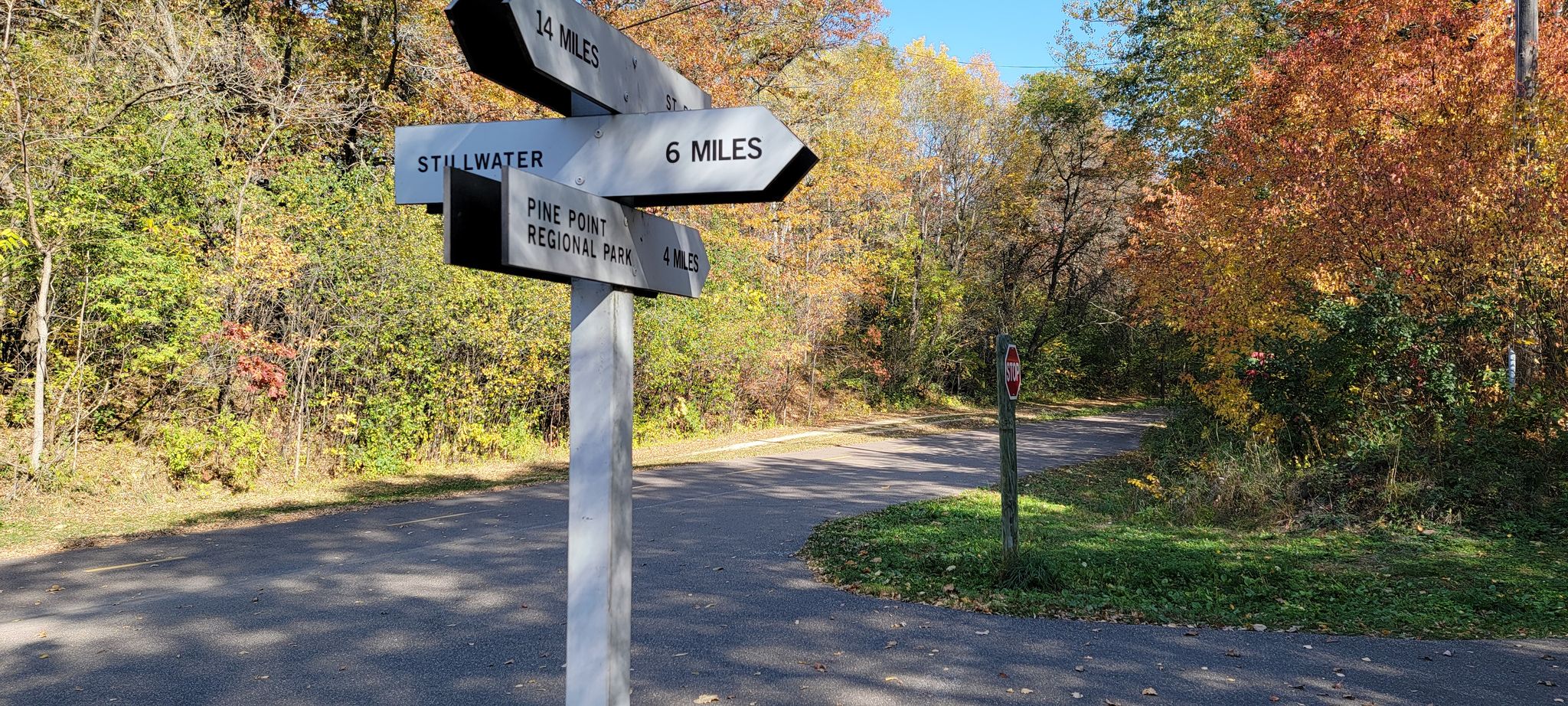 A signpost at a trail intersection, surrounded by colorful autumn trees. - Long Lake Park – Duluth Junction loop from Fridley