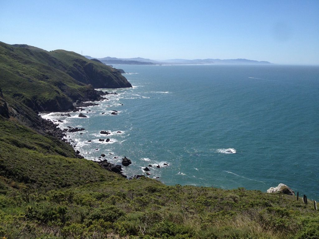 Sunny ocean coastline with rugged cliffs and crashing waves. - Miwok and Coastal Trail Loop