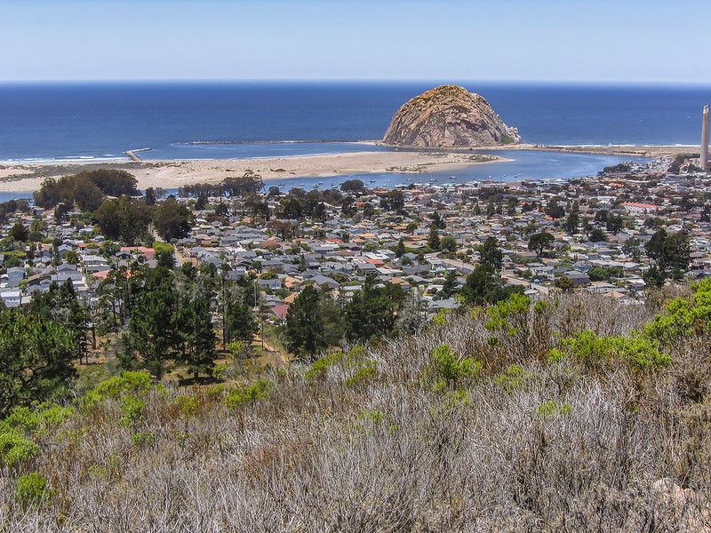 Panoramic view of a coastal town, ocean, and large rock under a clear sky. - Black Hill Loop via Exercise, Grove, and Pipeline Trail