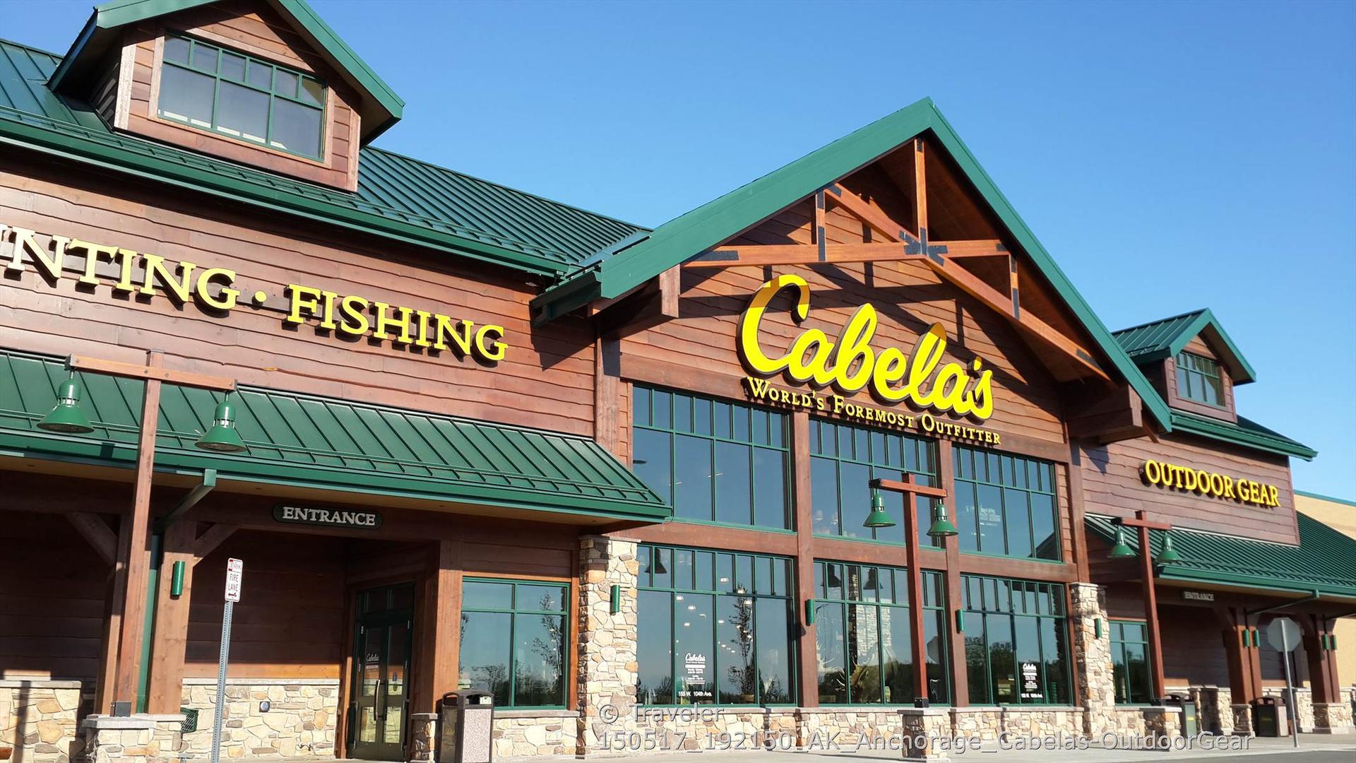 Large commercial building with a prominent "Cabela's" sign under a clear blue sky.