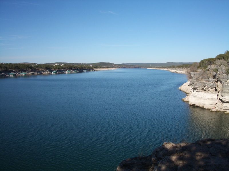Wide blue lake with rocky cliffs and distant shoreline under a clear sky. - Pace Bend National Park to Lakeway loop