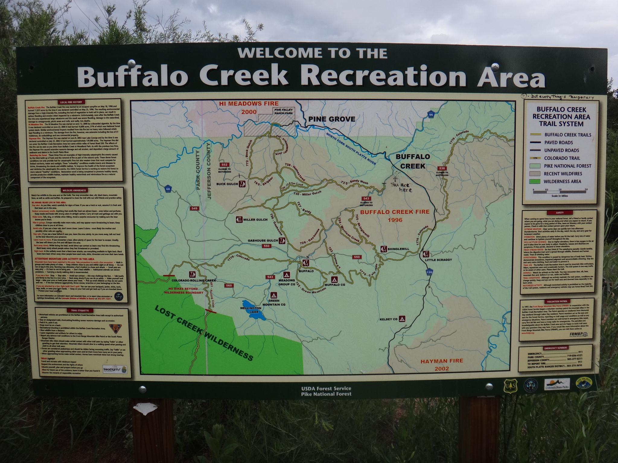 Large outdoor information sign displaying a detailed map and text.