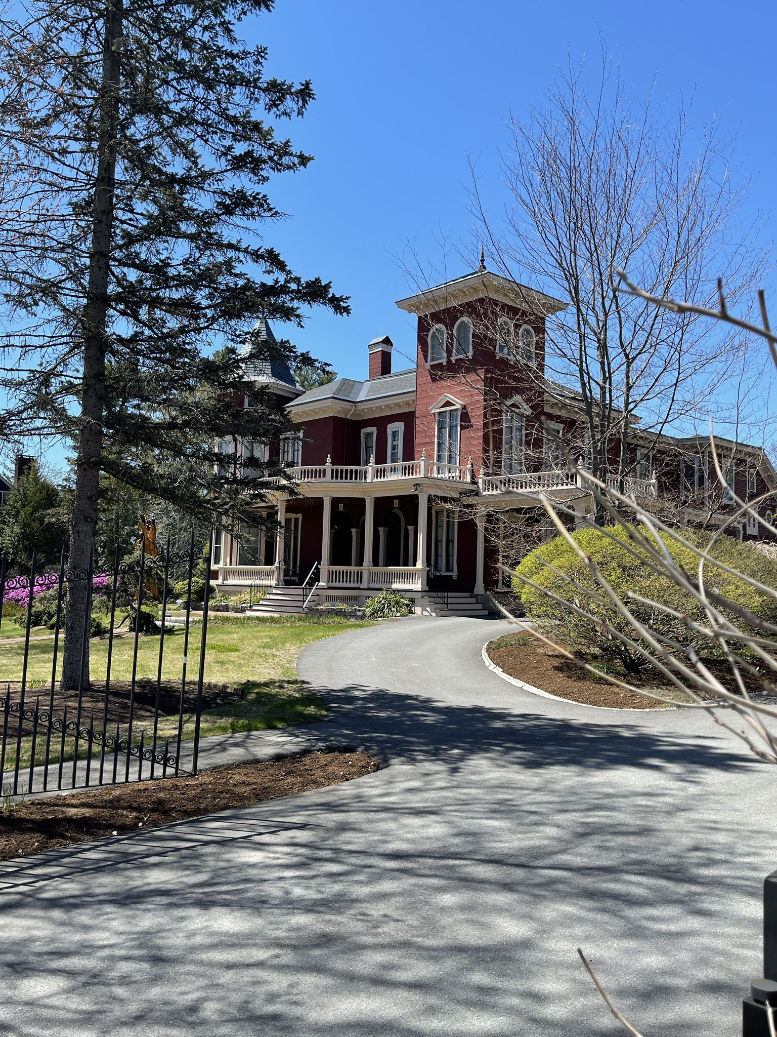 Large red Victorian house with a tower, sunny day, green trees. - Bangor Waterfront and Kenduskeag Stream Trail