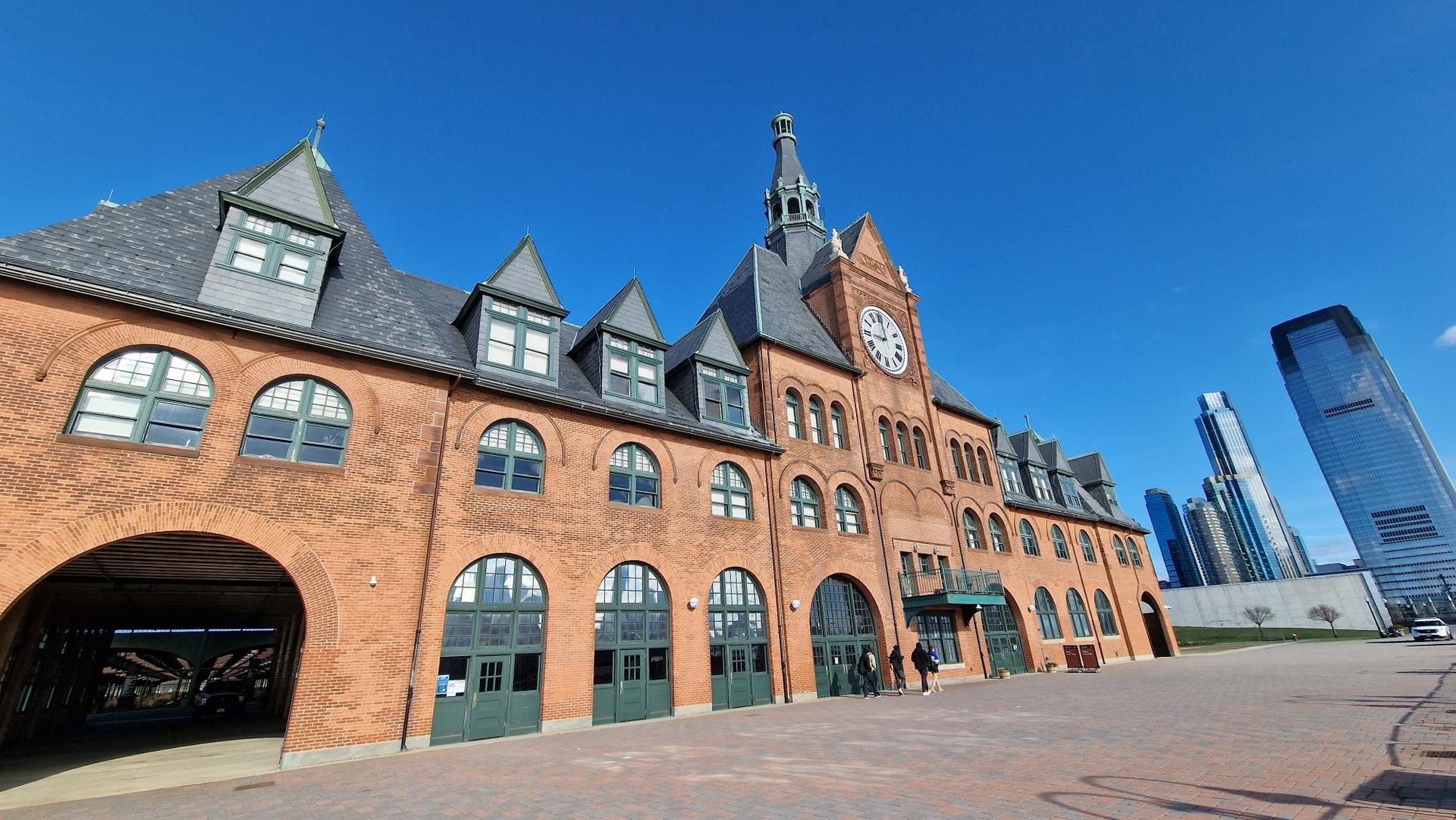 Historic brick building with a clock tower under a clear blue sky.