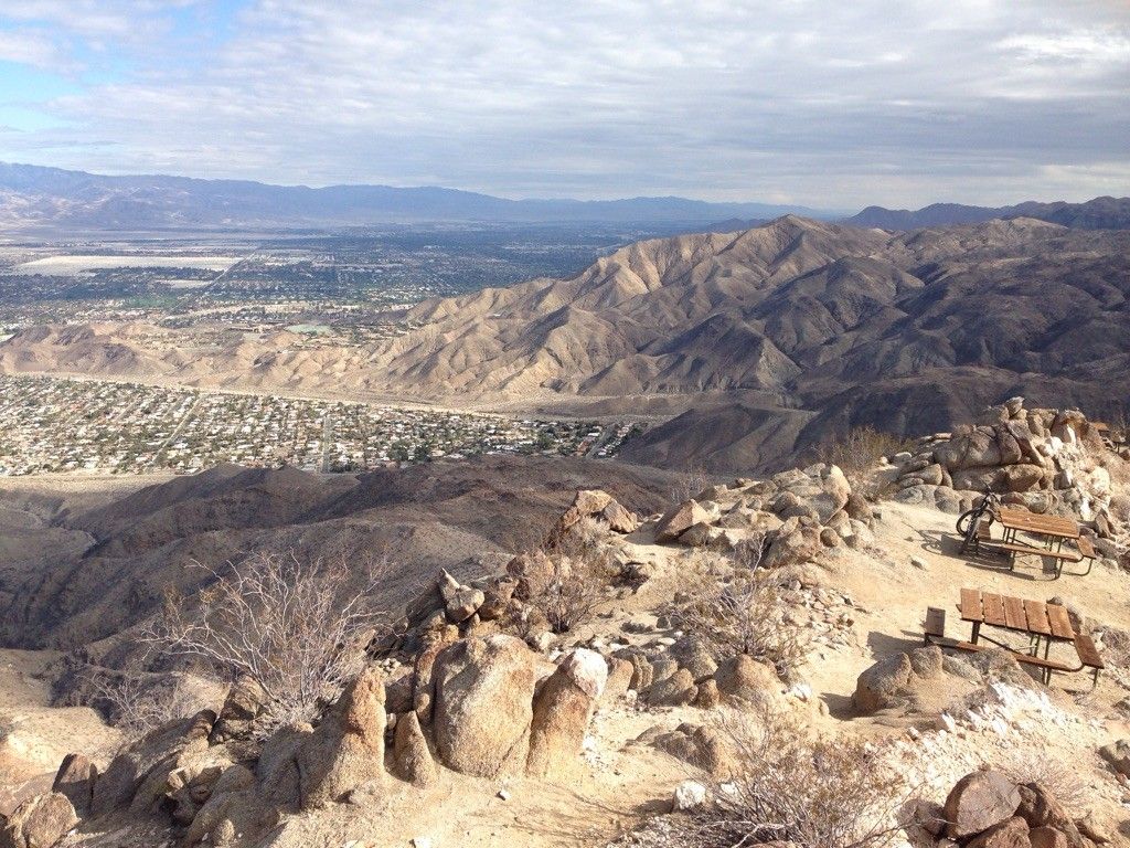 Rocky mountain vista overlooking a city, with two picnic tables. - Murray Hill Loop – San Bernardino National Forest