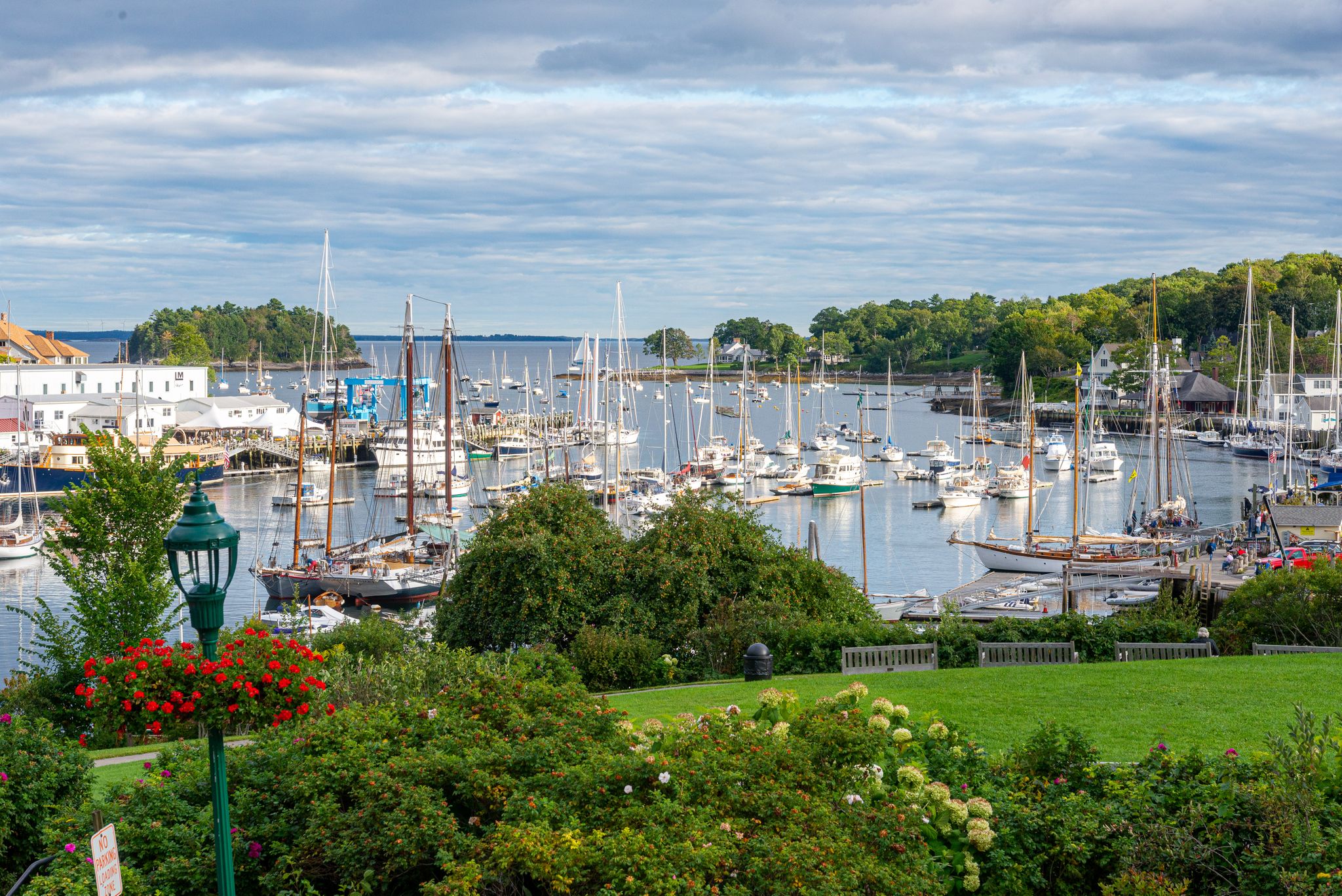 Many boats docked in a busy harbor under a cloudy sky. - Mount Battie & Eaton Point