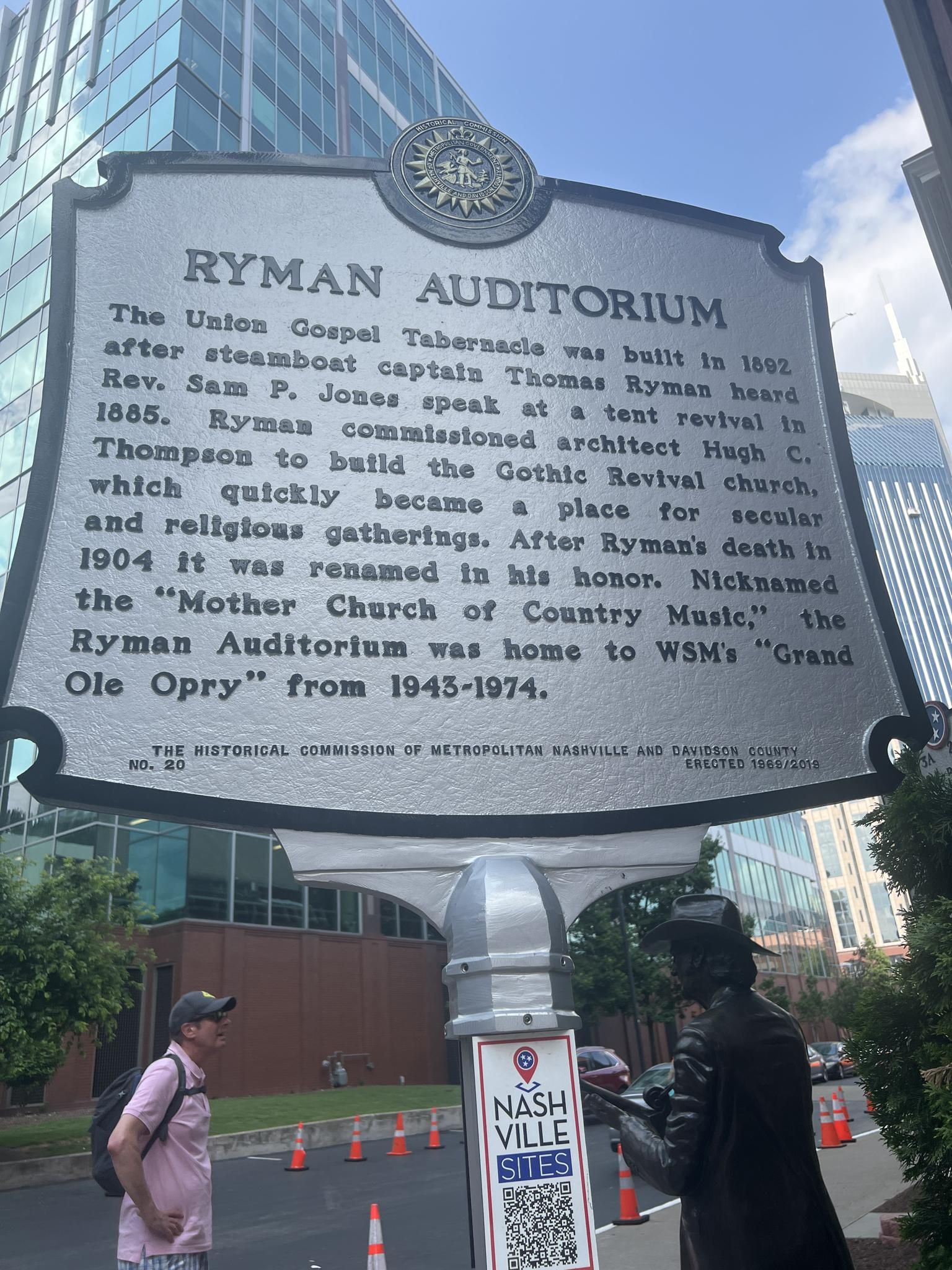 Large historical marker sign with text, two people standing nearby. - Downtown Nashville & Riverfront loop
