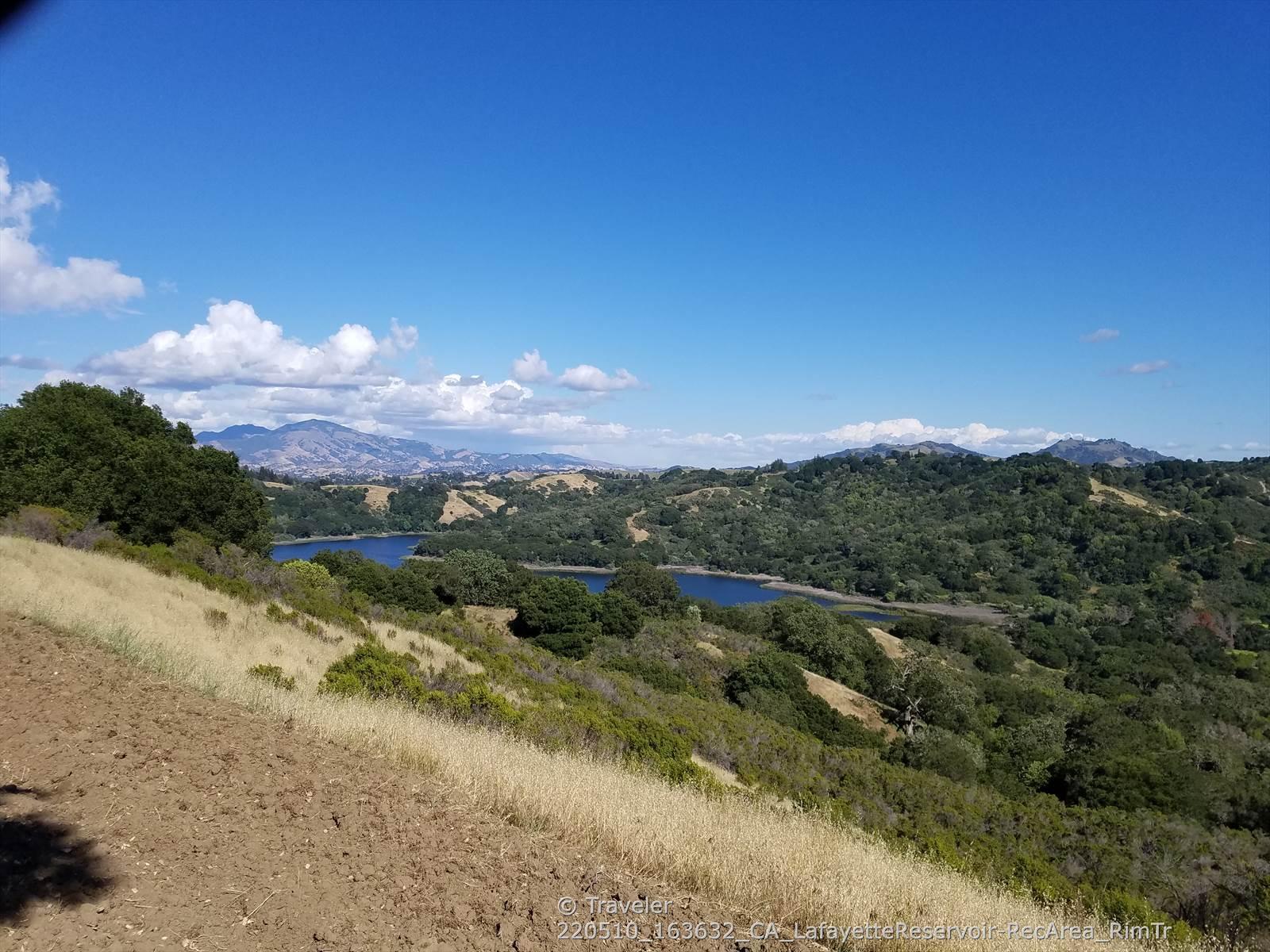 Panoramic view of two lakes in a valley surrounded by hills.