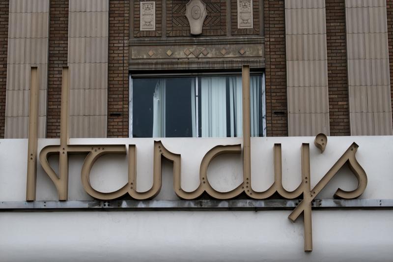 Close-up of a building facade with a 'Harcu's' sign and brickwork.