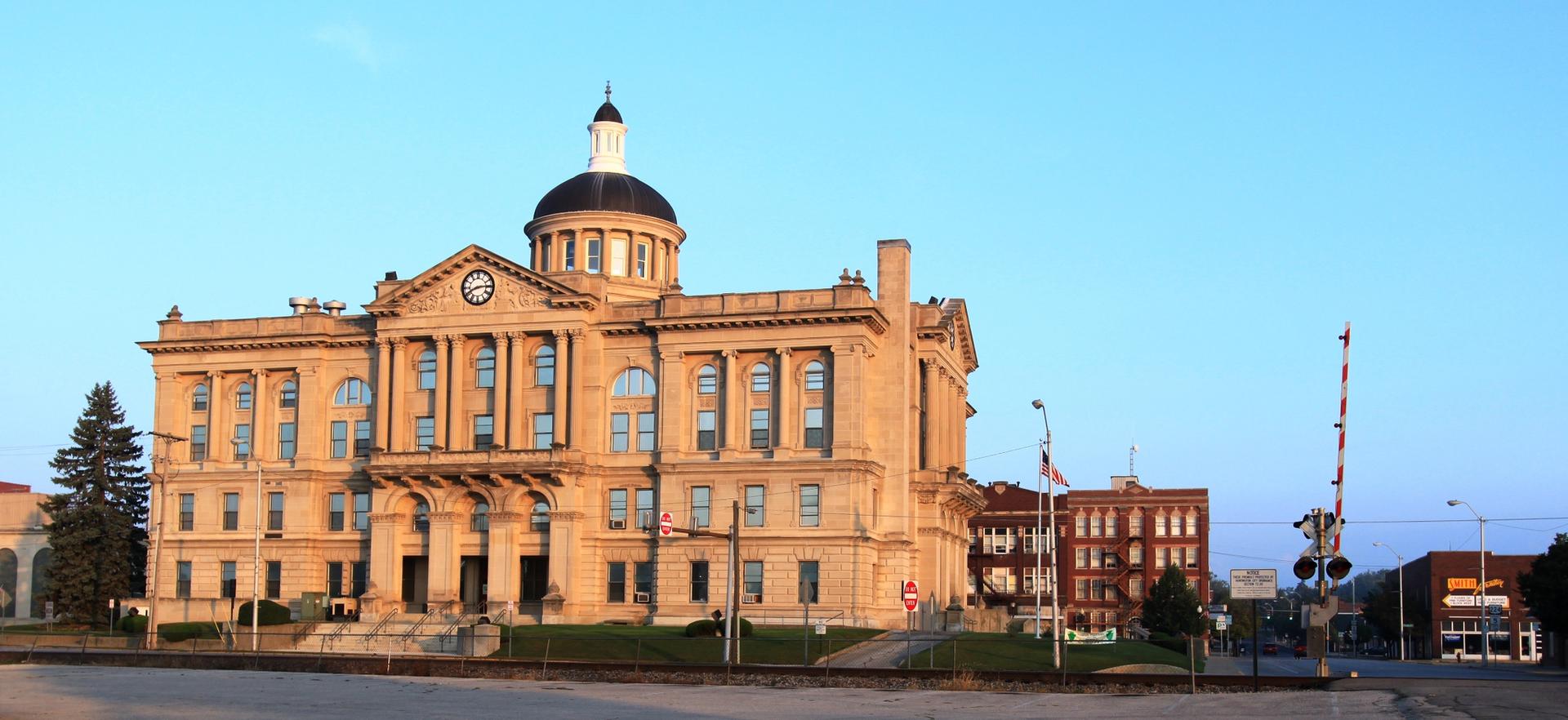 Grand historic building with a dome under a clear, bright sky.