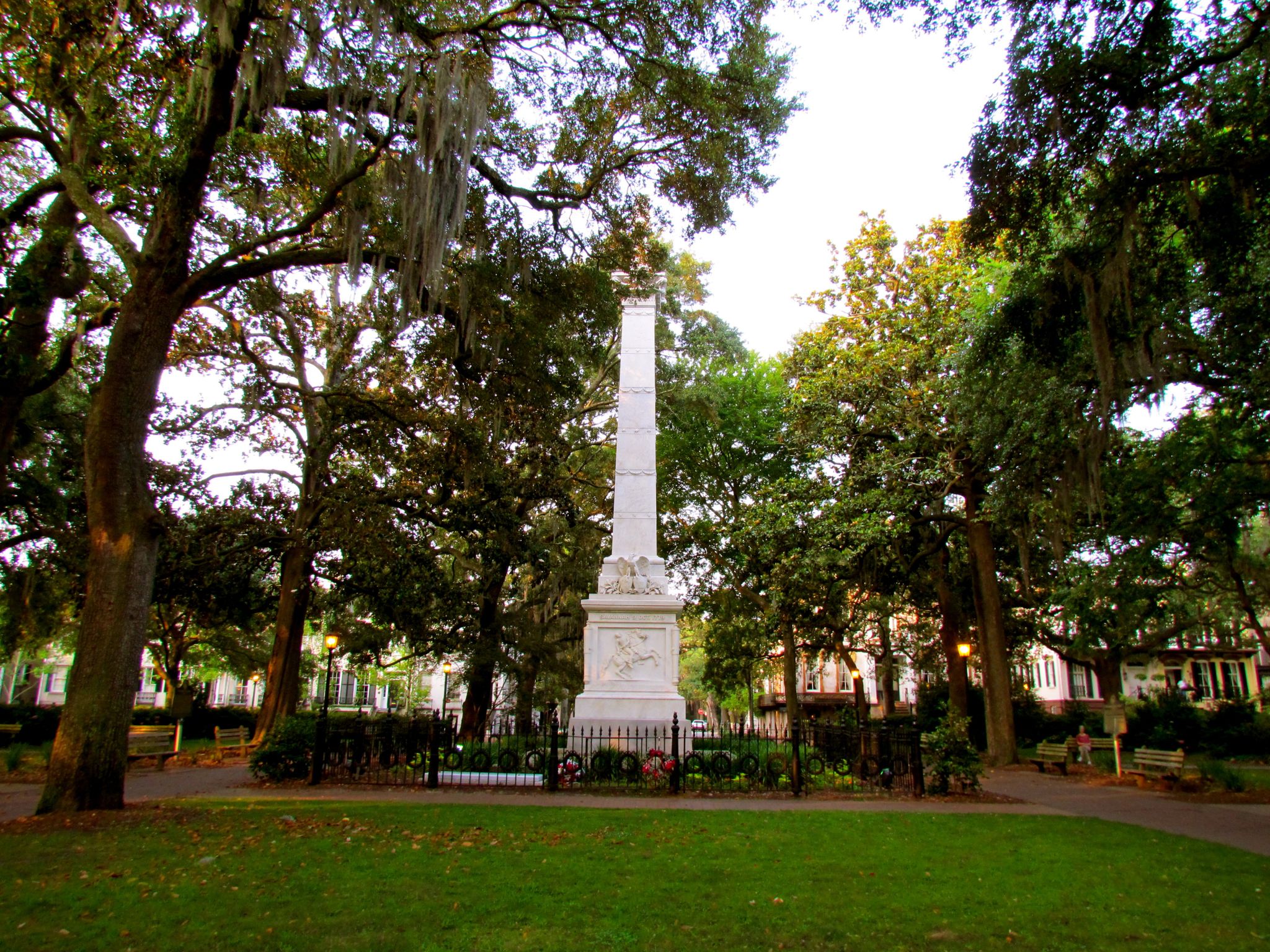 A tall white monument stands in a green park with large trees. - Savannah Riverfront to Forsyth Park Loop