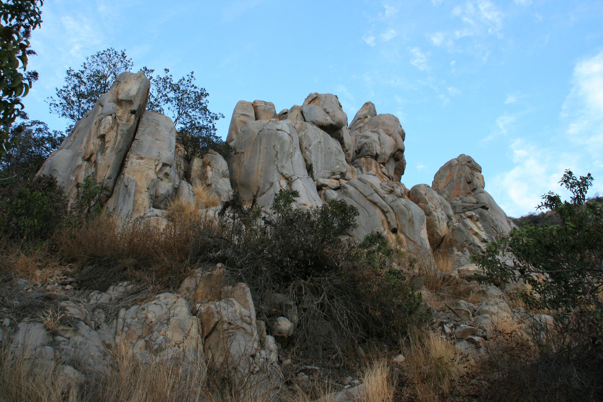 Towering light-colored rock formations against a bright blue sky.