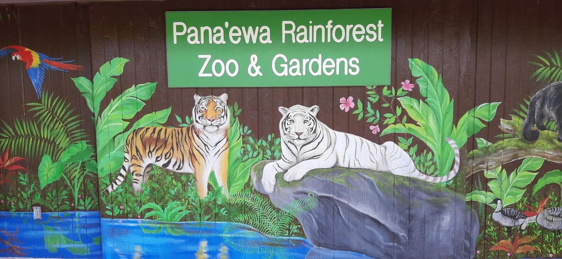 Brightly lit mural of jungle animals including tigers, a parrot, and a bear.