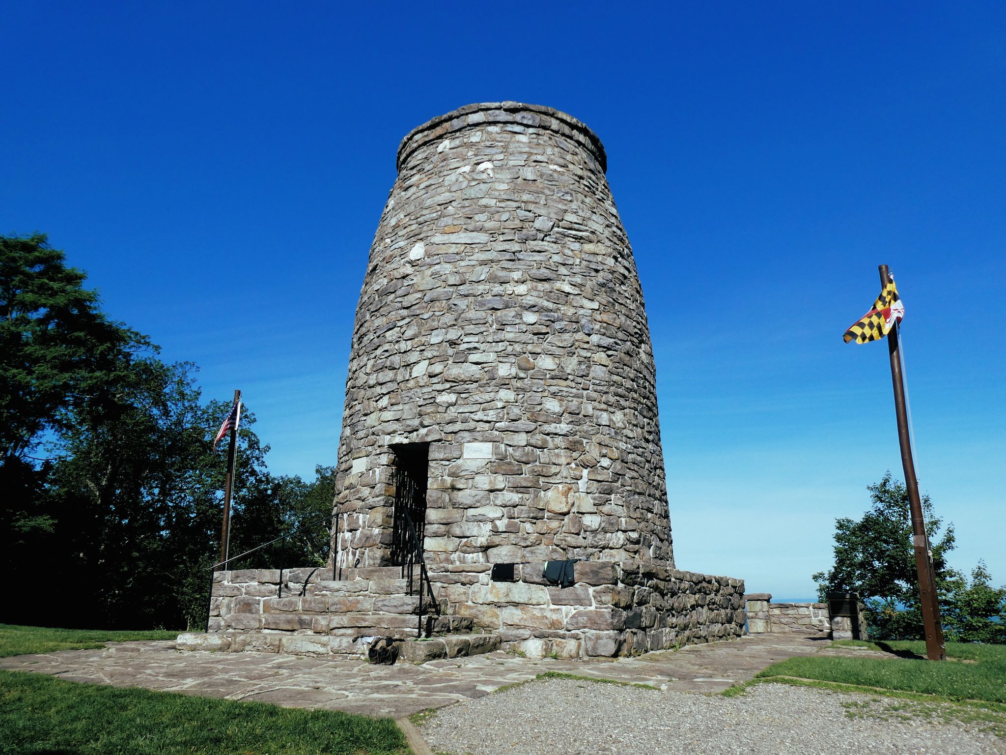A tall, cylindrical stone tower stands under a bright blue sky. - Appalachian Trail: Greenbrier to Washington Monument