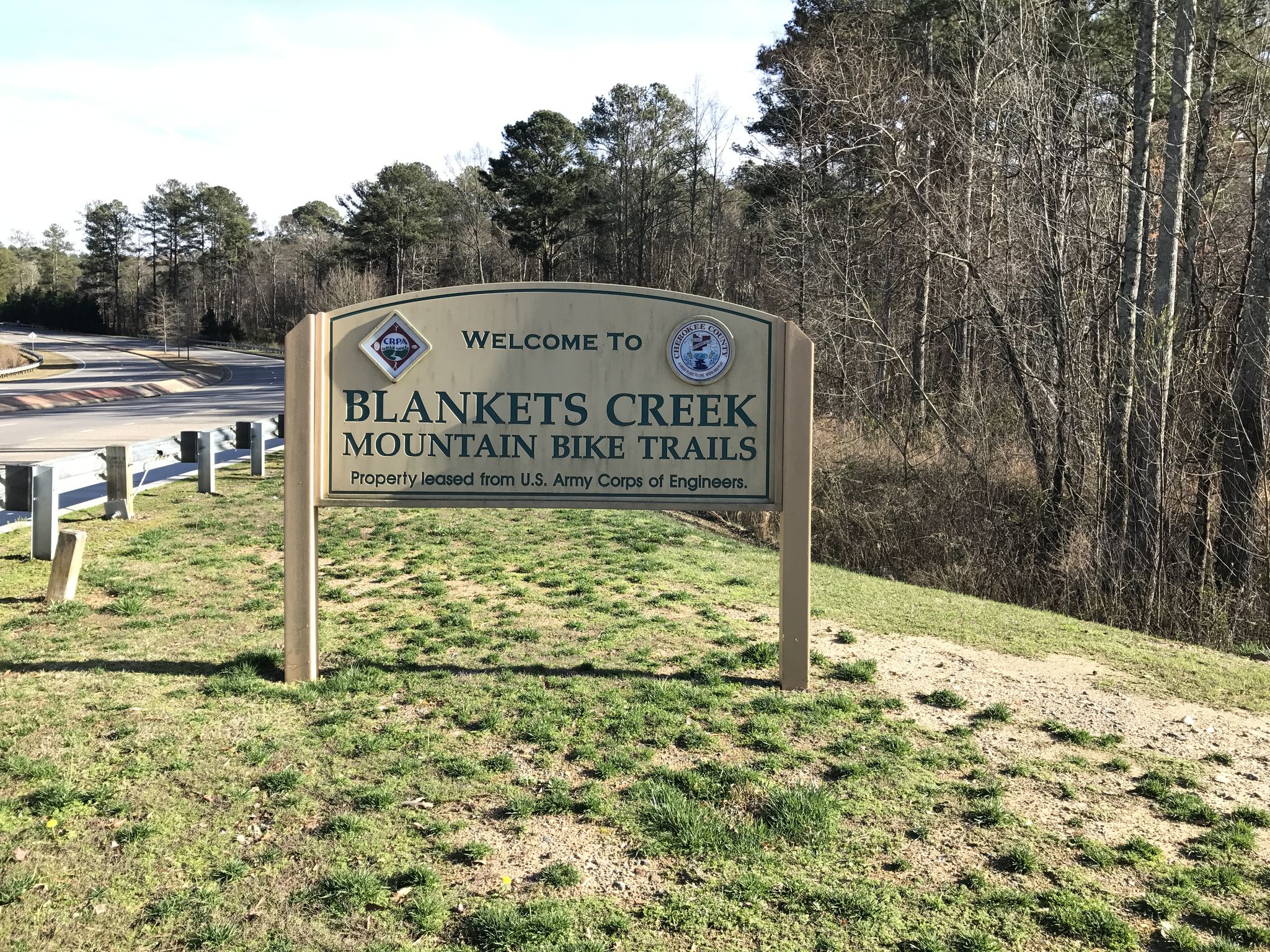 A wooden welcome sign for mountain bike trails on a sunny day. - VMT Trail (Van Michael Trail) loop from LakeSovereign