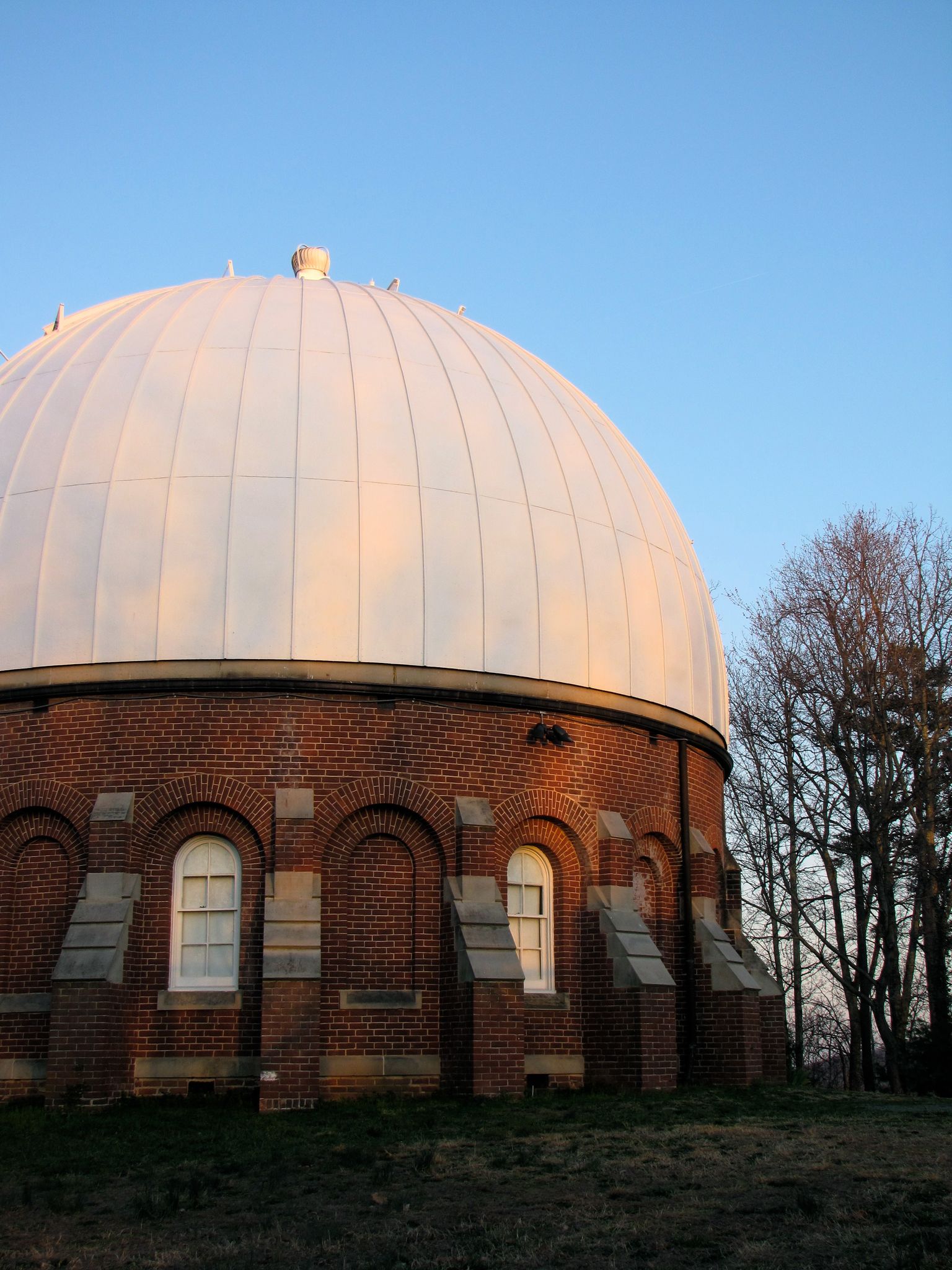 Brick observatory building with a large white dome under a clear blue sky. - O-Hill Black Loop