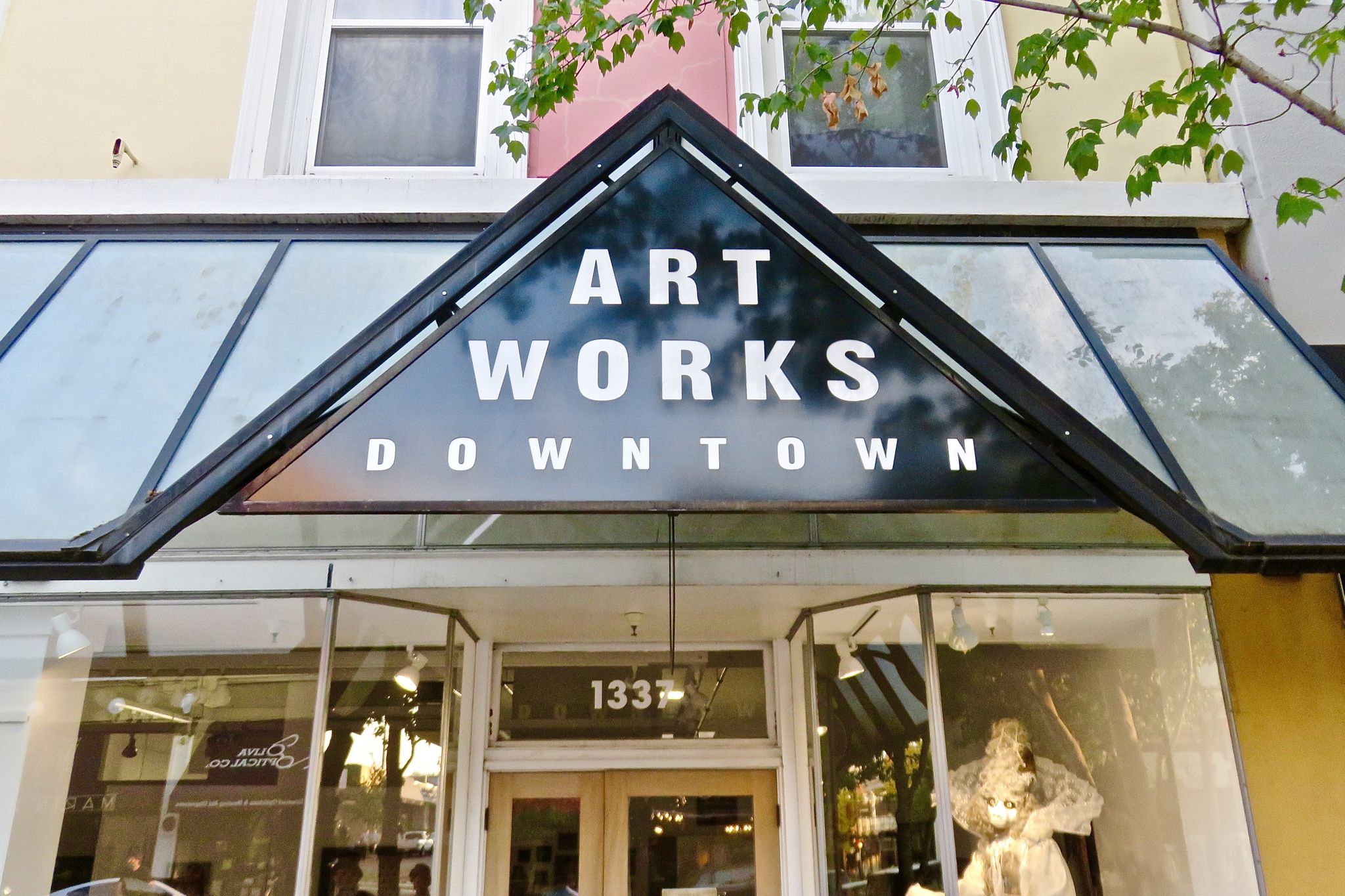 A storefront sign reads 'ART WORKS DOWNTOWN' on a bright day. - San Rafael City Tour loop