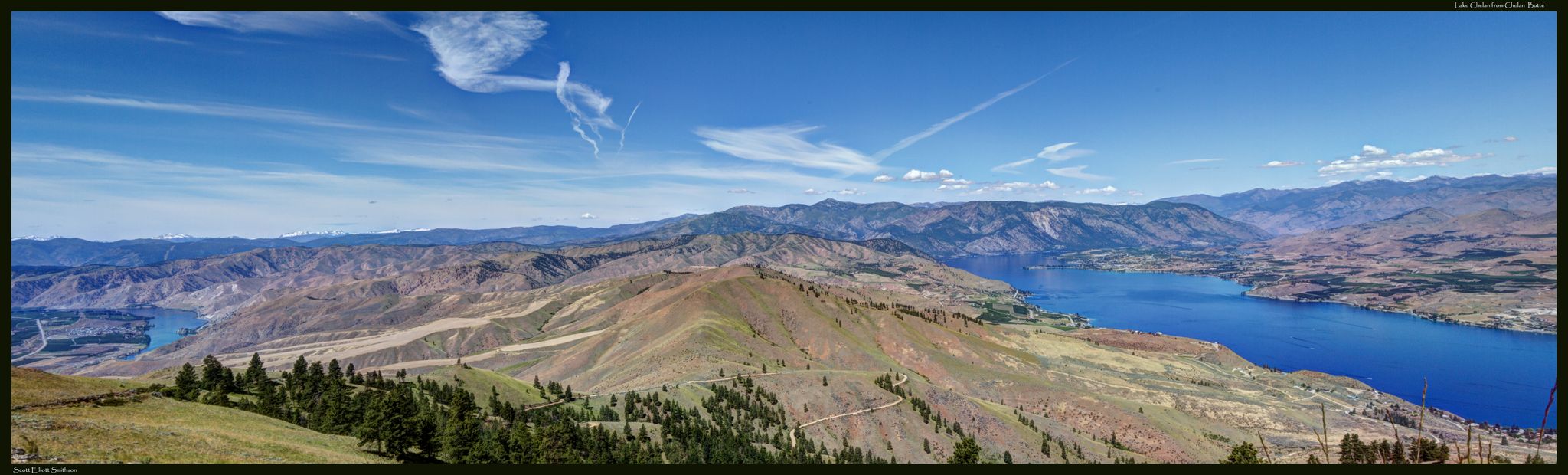 Expansive mountain landscape with a bright blue lake under a clear sky. - Chelan Butte Trail