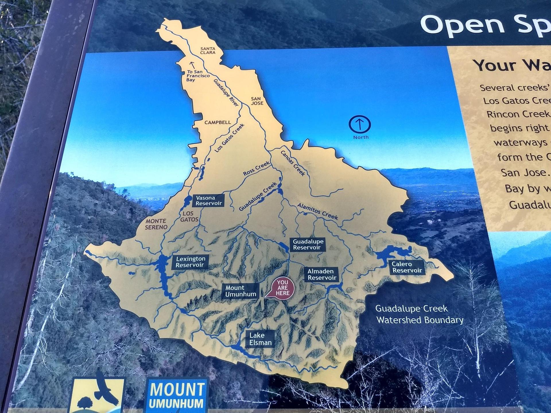 Close-up of an outdoor information sign displaying a watershed map.