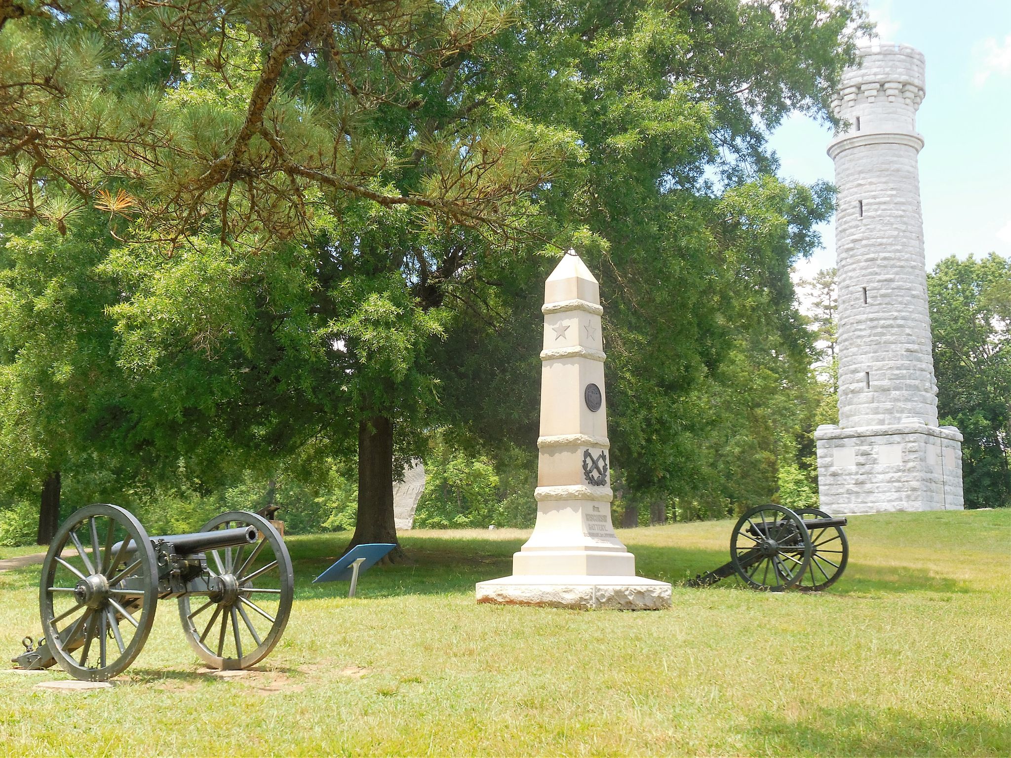 Two cannons, a tall monument, and a stone tower on a sunny, grassy hill. - Chickamauga & Chattanooga National Military Park loop