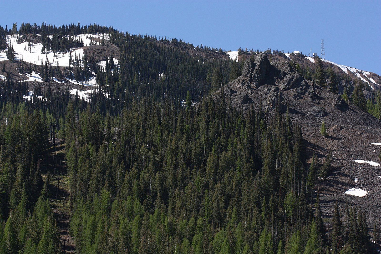 Forested mountain slopes with snow patches and rocky outcrops under a clear sky. - Squilchuck Trail to Clara and Marion Lakes
