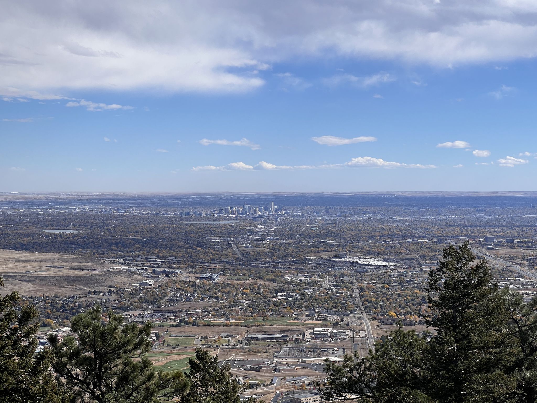 Panoramic view of a distant city skyline and vast landscape under a bright blue sky. - Colorado Railroad Museum to Lookout Mountain Nature Preserve
