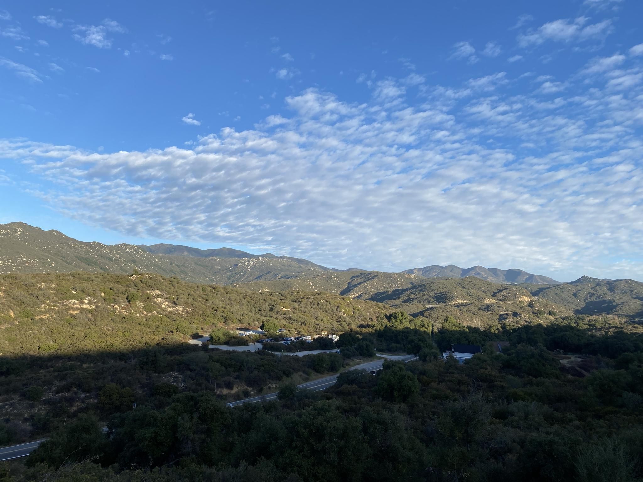 Expansive view of green, rolling hills and valleys under a partly cloudy sky. - Sitton Peak via Bear Canyon and Bear Ridge Loop