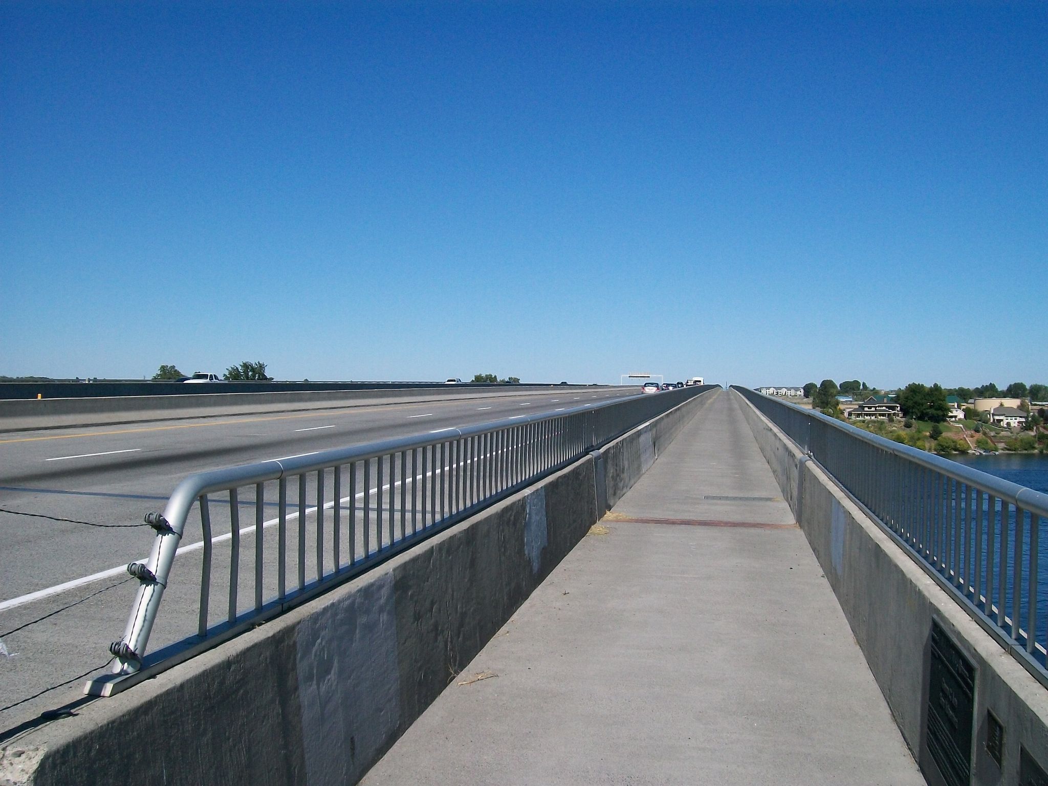 Long bridge with a pedestrian walkway and highway lanes under clear sky. - Keene Road Trail loop from Richland Y