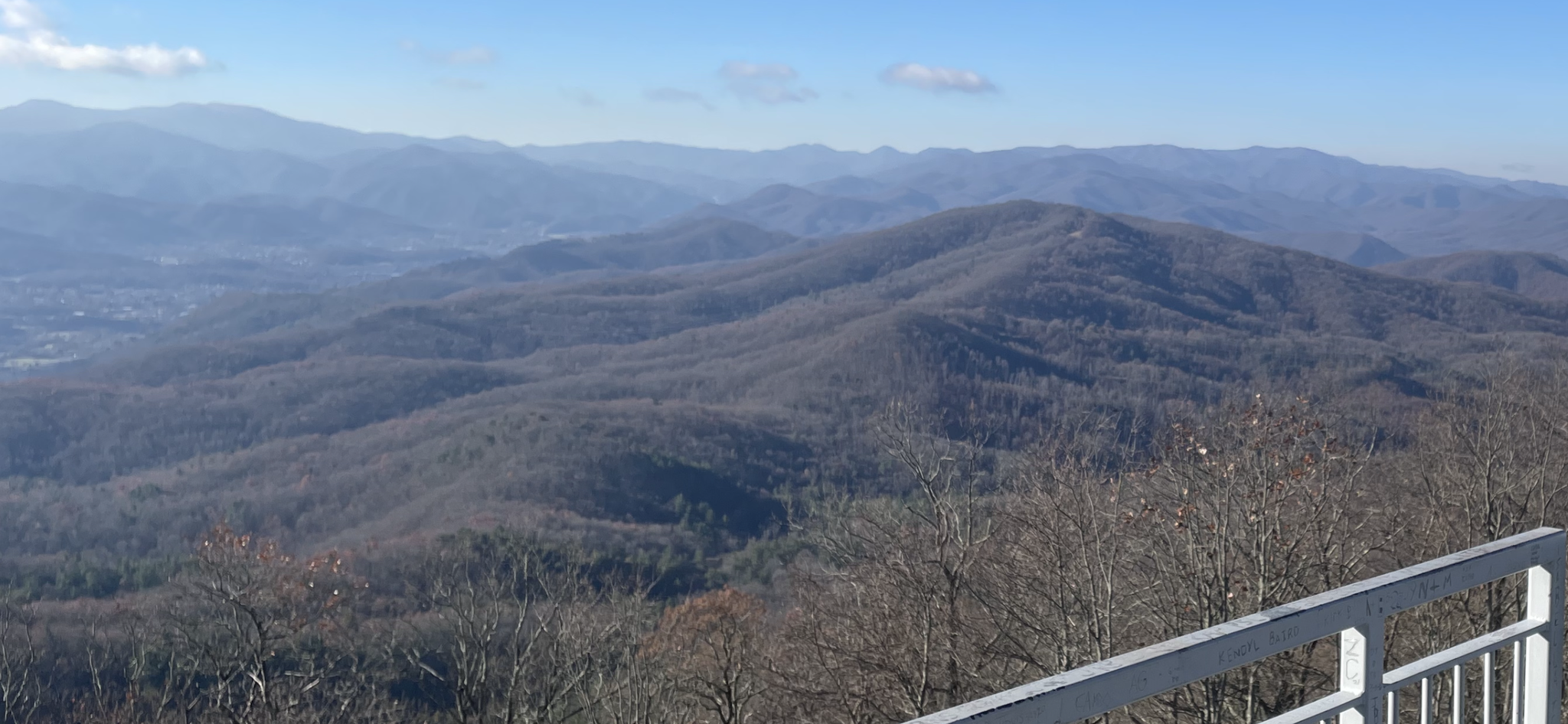 Panoramic view of hazy mountains and bare winter trees under a clear sky. - Mountainbike loop from Pinnacle Mountain